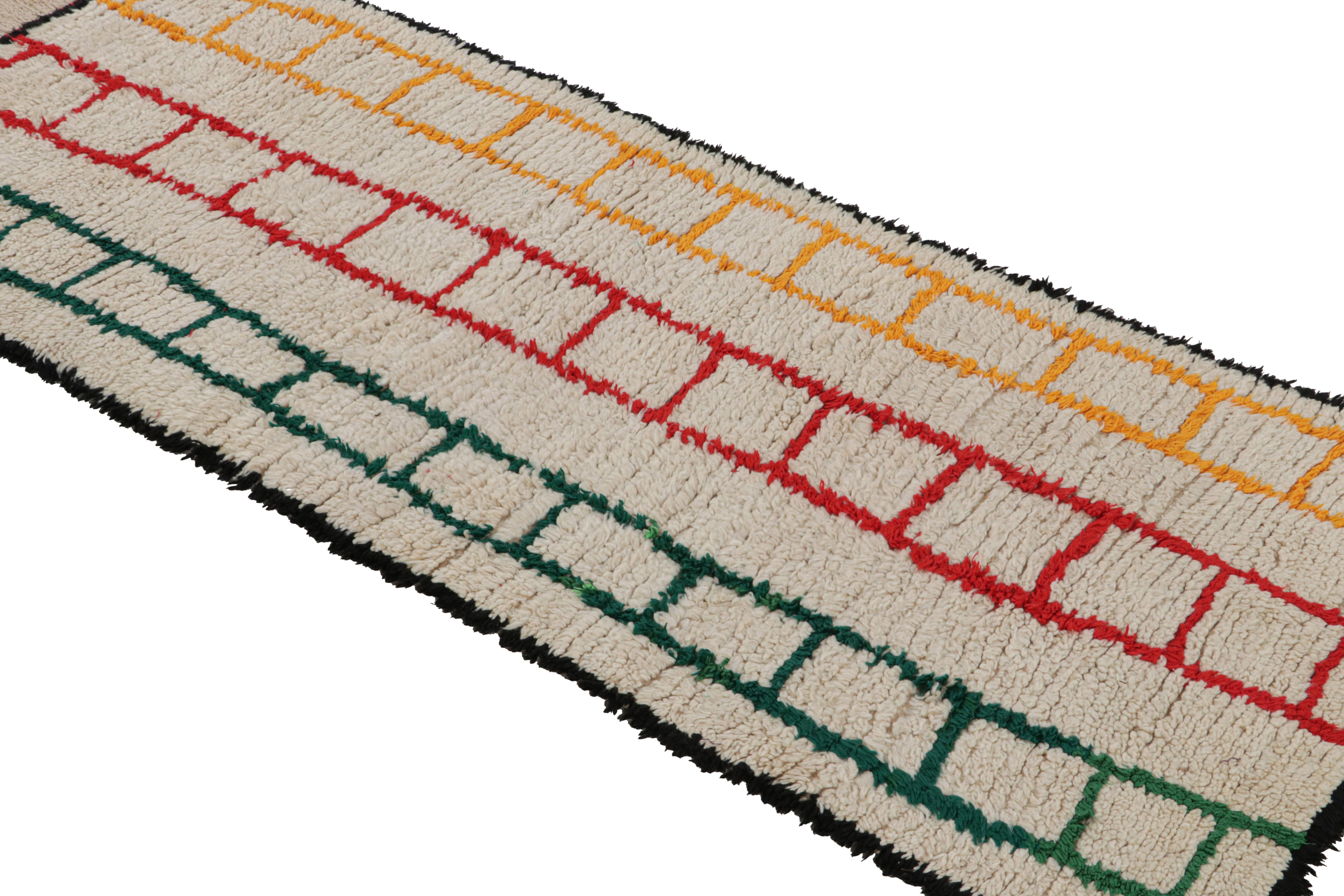 Hand-knotted in wool circa 1950-1960, this vintage 3x7 Moroccan runner is believed to hail from the Azilal tribe. 

On the Design: 

This runner enjoys geometric patterns that appear like a ladder. The simple design in red, green and gold sits