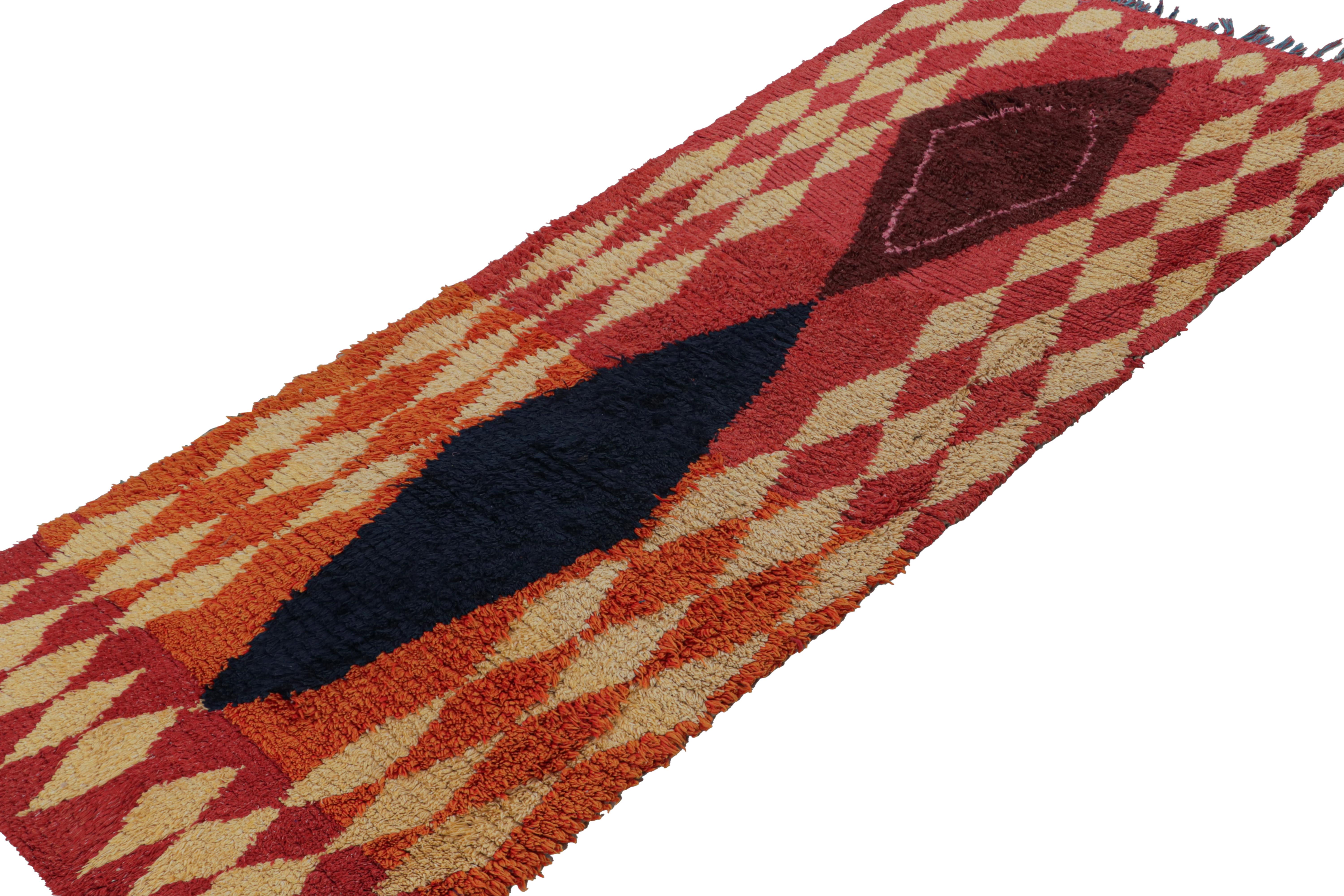 Hand-knotted in wool circa 1950-1960, this vintage 3x9 Moroccan runner is believed to hail from the Azilal tribe. 

On the Design: 

The runner enjoys beige, blue and maroon diamond patterns on a red-orange background. Keen eyes will further admire