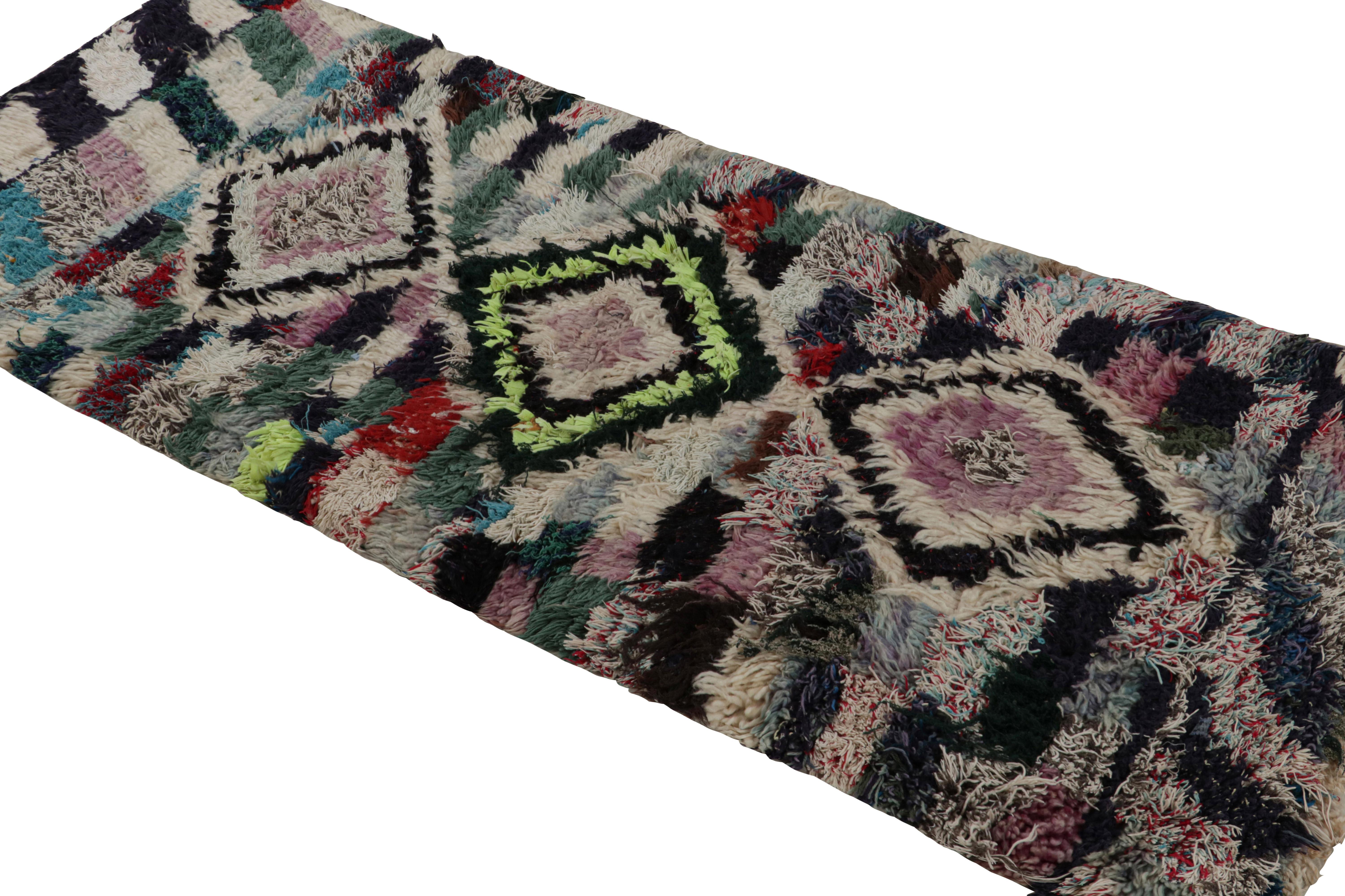 Hand-knotted in wool circa 1950-1960, this vintage 3x7 Moroccan runner is believed to hail from the Azilal tribe. 

On the Design: 

Keen eyes will particularly note a colorful play of diamond lozenges and geometric patterns in a polychromatic style