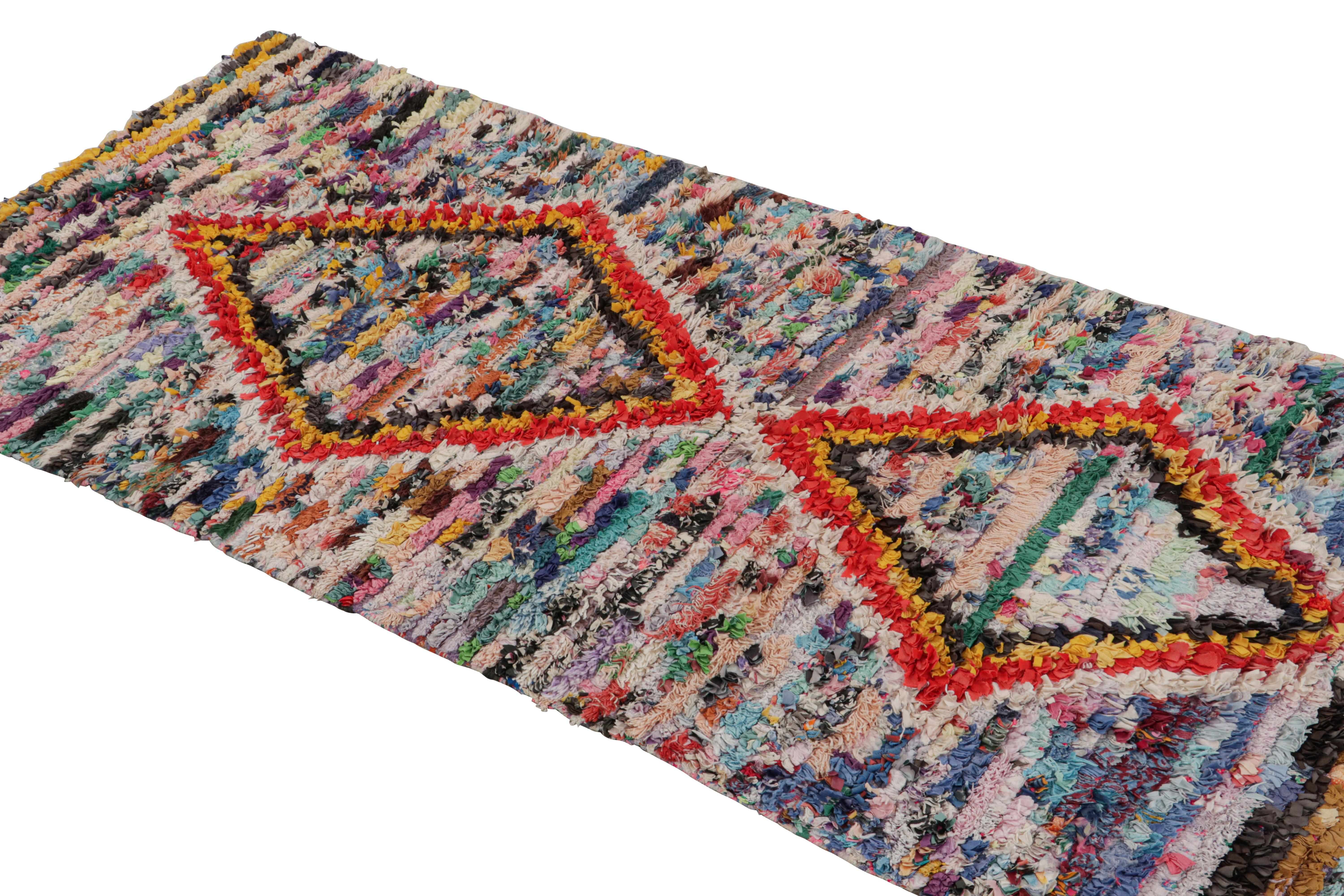 Hand-knotted in wool circa 1950-1960, this vintage 3x6 Moroccan runner rug is believed to hail from the Azilal tribe. 

On the Design: 

This runner enjoys red, gold and black diamond patterns on a polychromatic background. Keen eyes will further