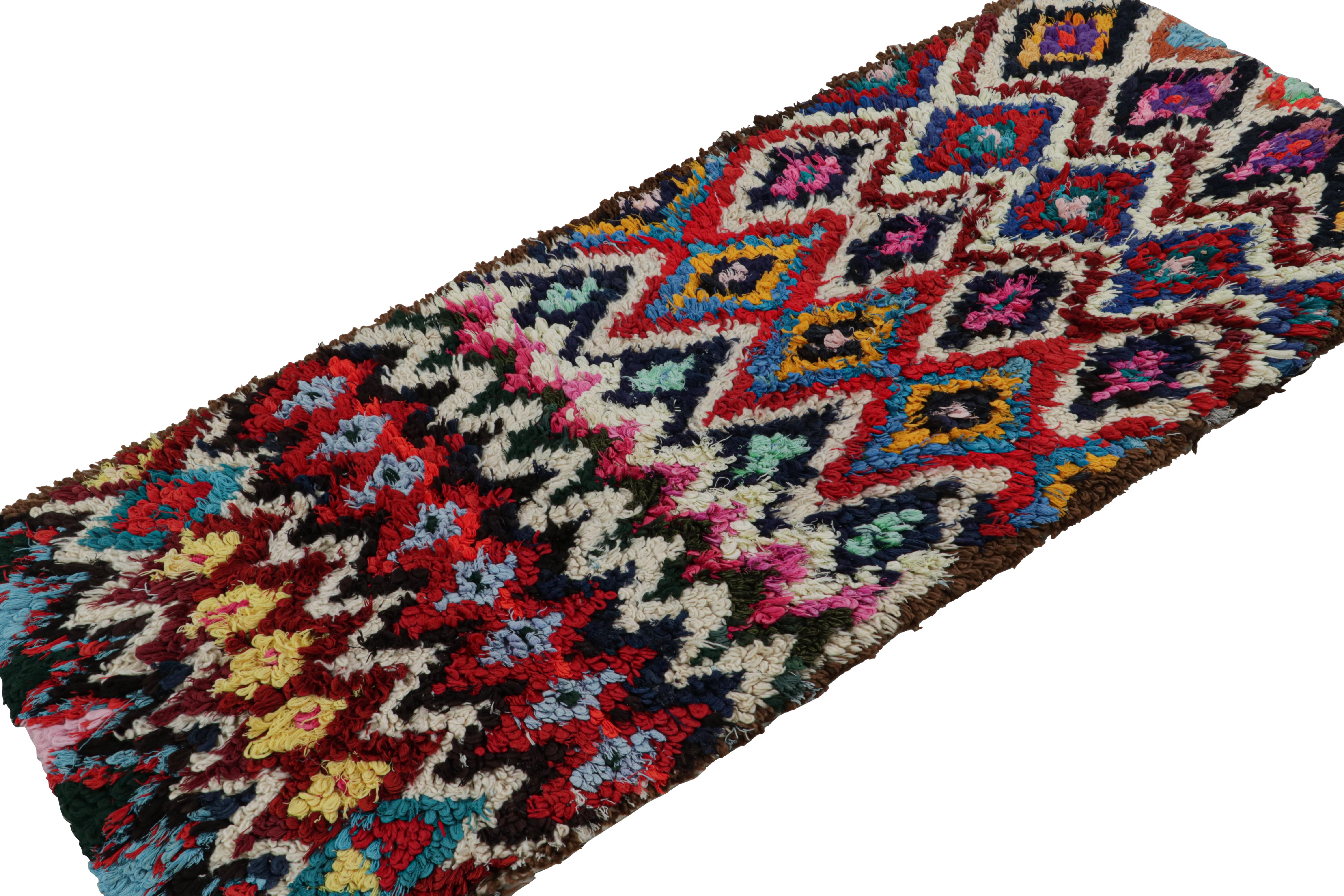 Hand-knotted in wool and fabric circa 1950-1960, this vintage 3x7 Moroccan Boucherouite runner is believed to hail from the Azilal tribe. 

On the Design: 

This runner enjoys a whimsical play of red, blue, black, green and gold in the geometric