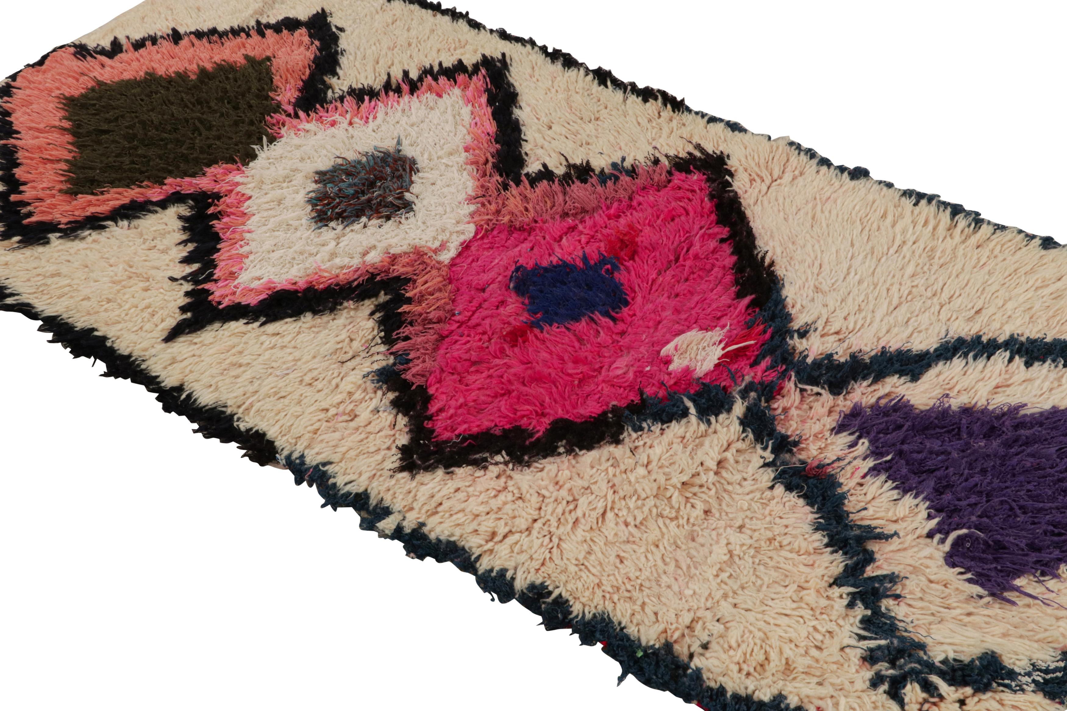 Hand-knotted in wool circa 1950-1960, this vintage 2x5 Moroccan runner is believed to hail from the Azilal tribe. 

On the Design: 

The runner boasts colorful diamond lozenge patterns on a beige open field. Keen eyes will further note a