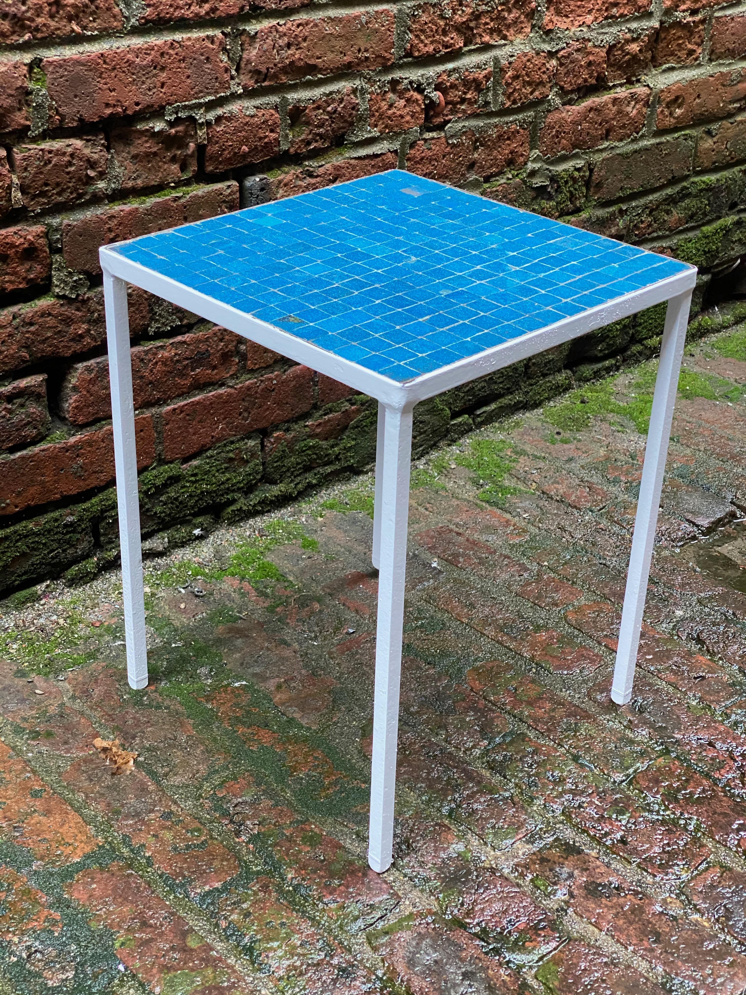 Vibrant blue glass tile table with an iron base. Italian glass tiles, circa 1950-60. Good overall condition with some flawed and chipped tiles.

Measures: 12.63