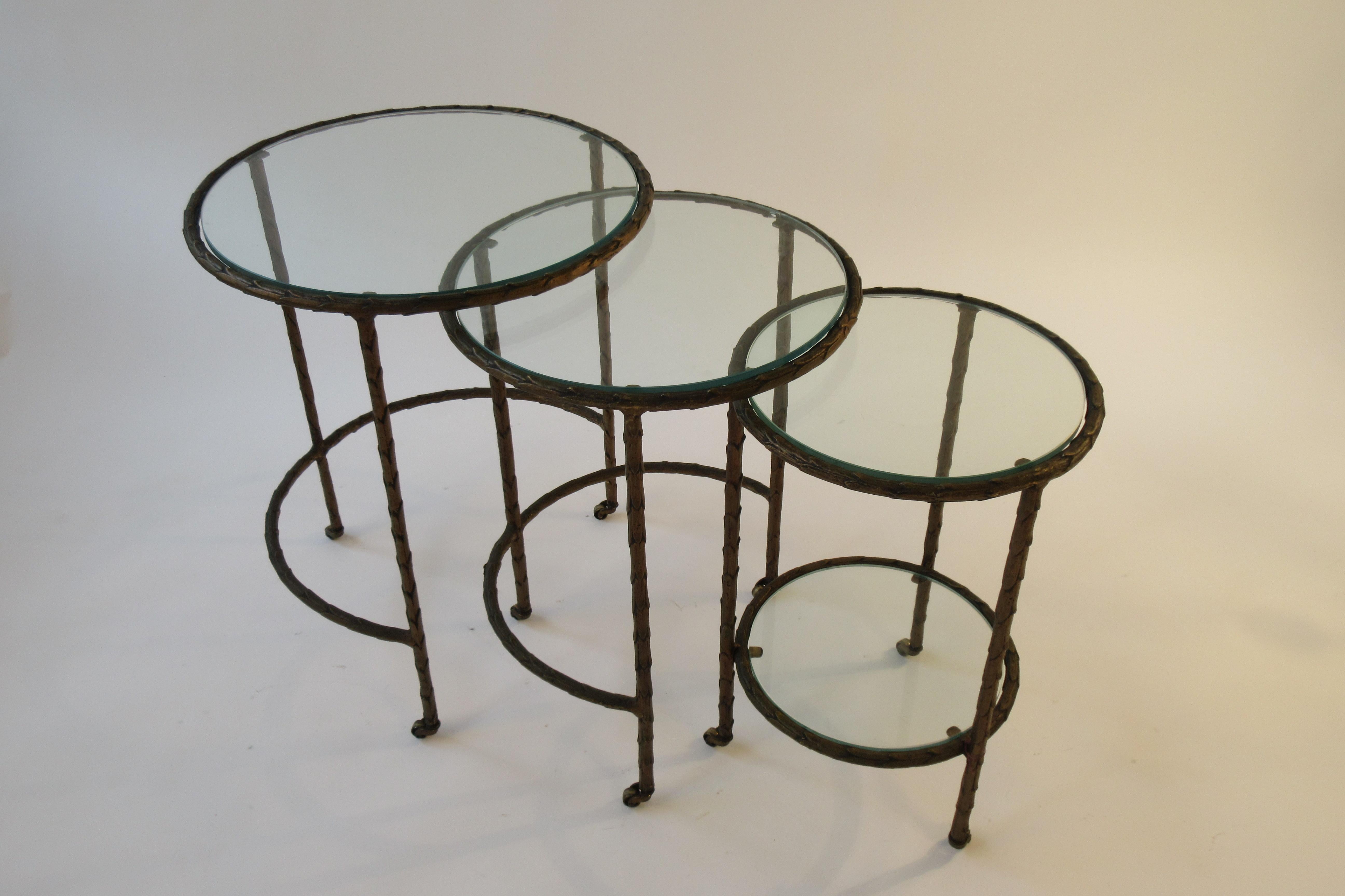 1950s Baguès bronze circular nesting tables. All three tables sit together to form one table. Unfortunately our pictures came out very dark, these tables are bronze.
