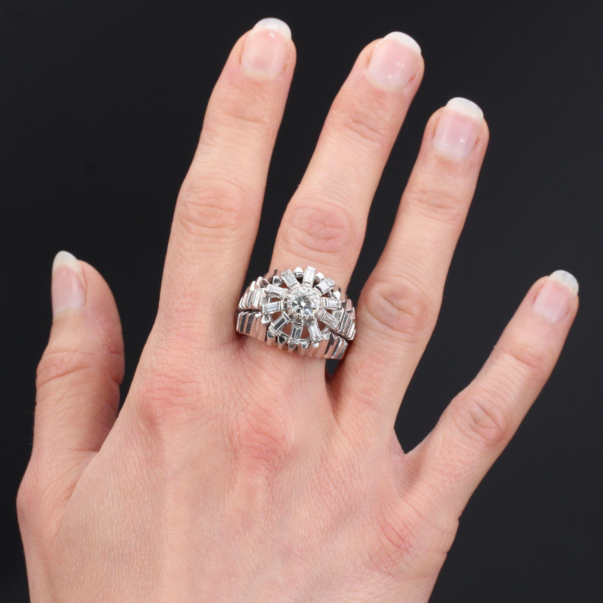 Ring in 18 karat white gold ring, owl hallmark.
An important domed ring, its setting consists of a triple row of prism motifs with openwork between them. The top of the ring is set with an antique brilliant-cut diamond in an openworked baguette-cut