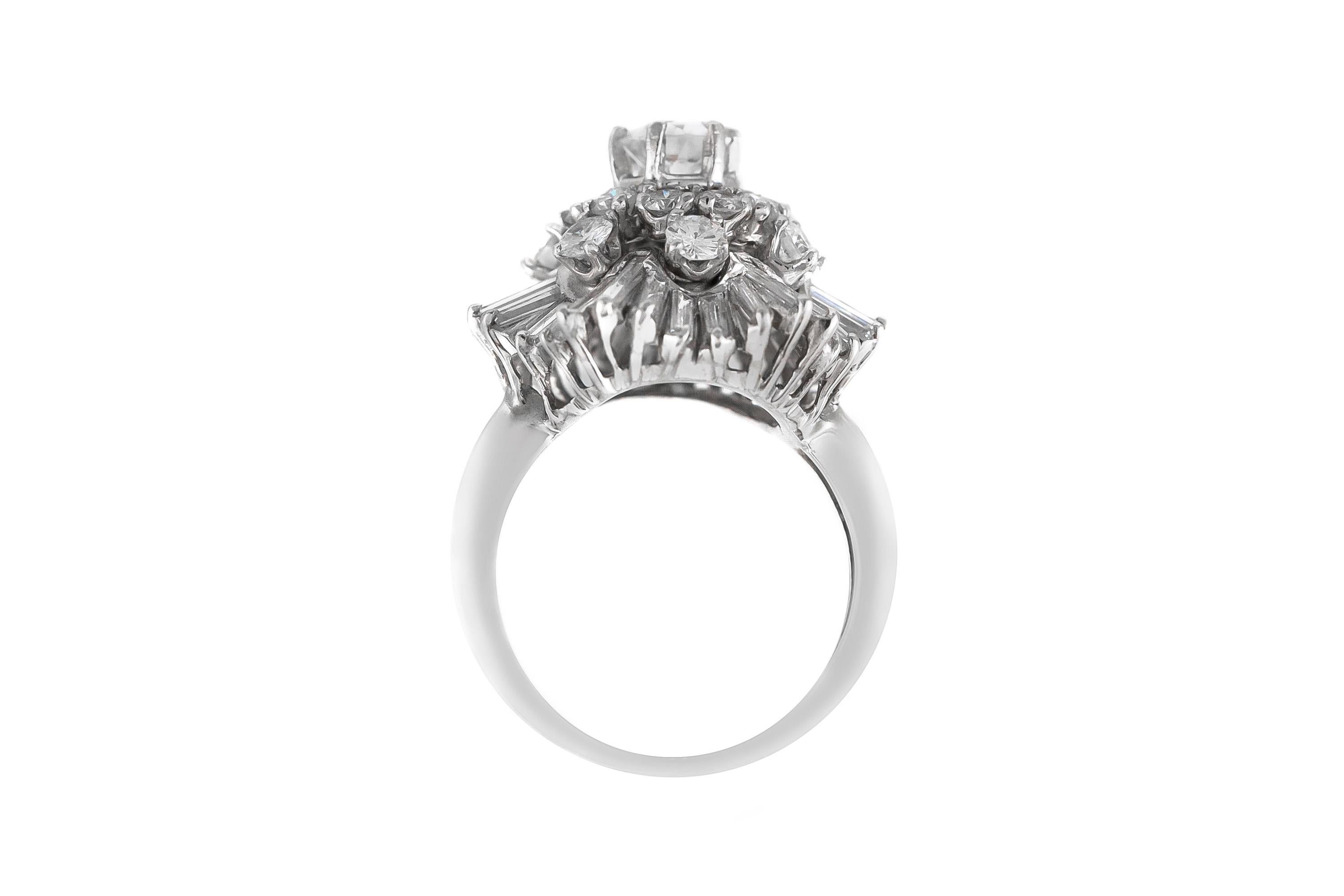 The ring is finely crafted in  platinum with different diamonds cut weighing approximately total of center 0.60 carat ,all rounds diamonds 1.20 carat and baguettes 2.00 carat.
Size 6.00 ( easy to resize)
Circa 1950.