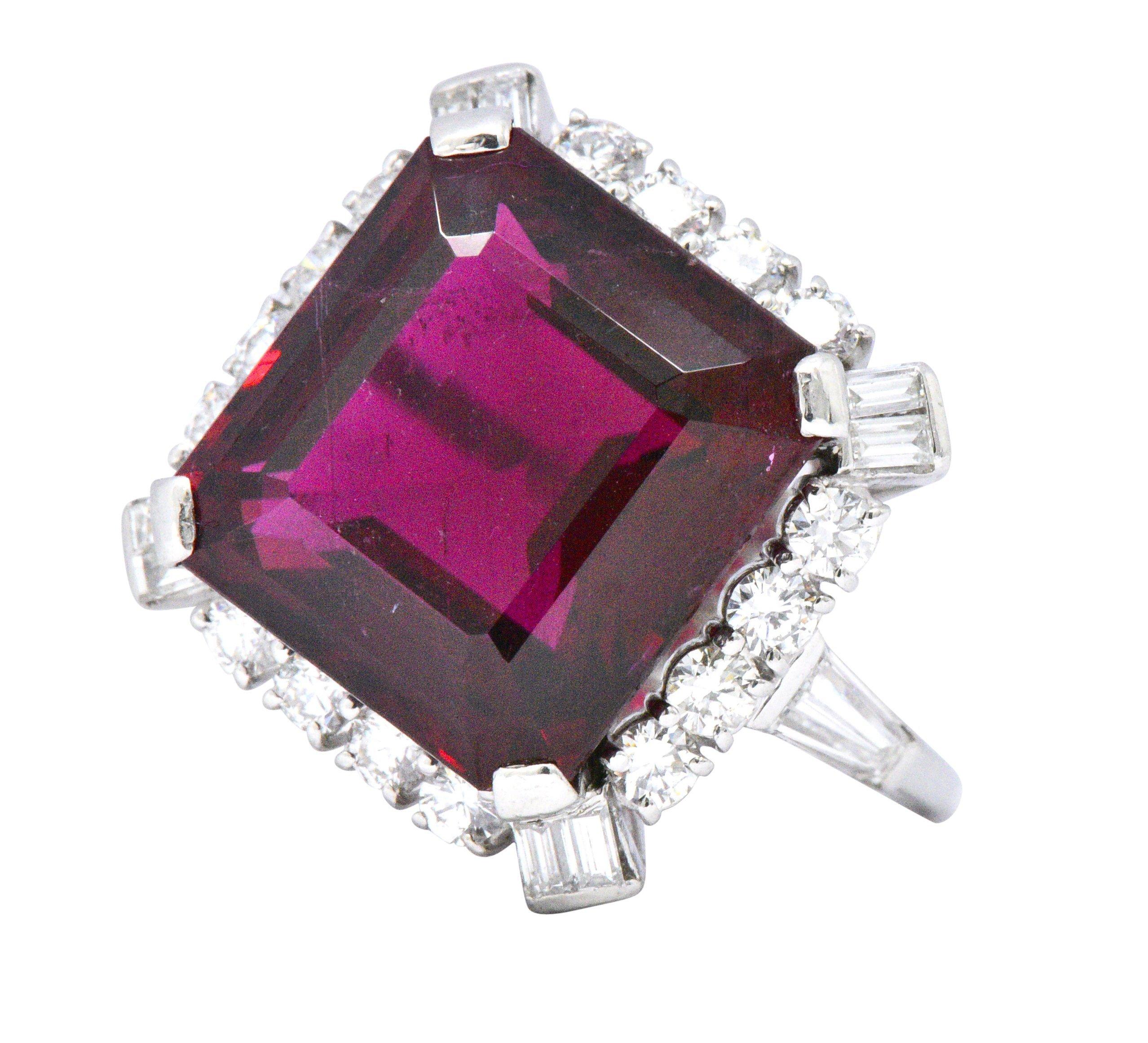 Centering a square cut rubellite tourmaline weighing 11.77 carats with a deep burgundy color

Encompassing center stone are round and baguette cut diamonds weighing 1.60 CTW, F-G color and VS clarity

Tested as platinum and circa 1950

Top measures