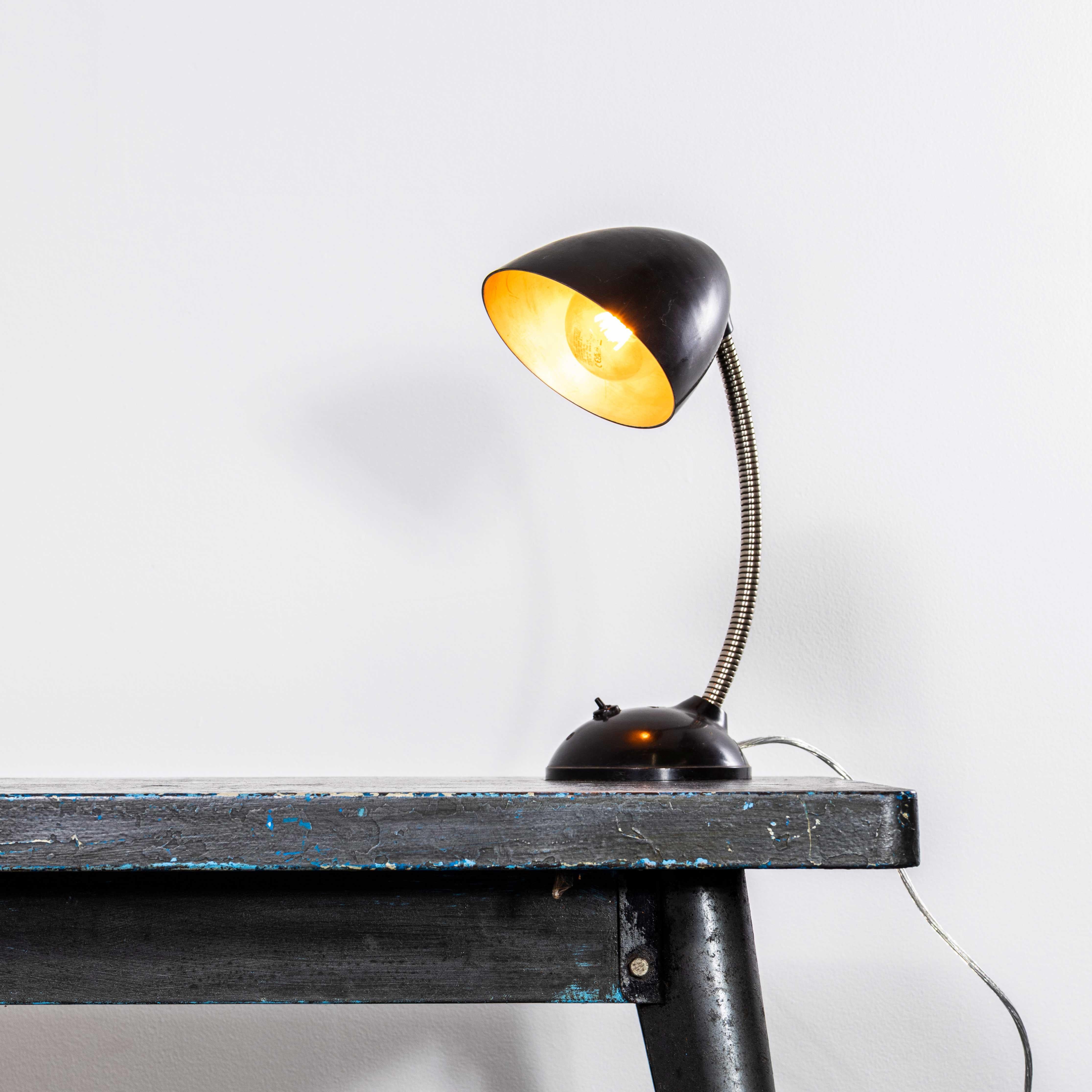 1950’s Bakelite Early Flexible Desk Lamp. 
The lamp was produced in Eastern Europe in the fifties and widely used in the mid century period. The lamp base is Bakelite, the shade is light spun aluminium. The lamp has been cleaned and restored but we