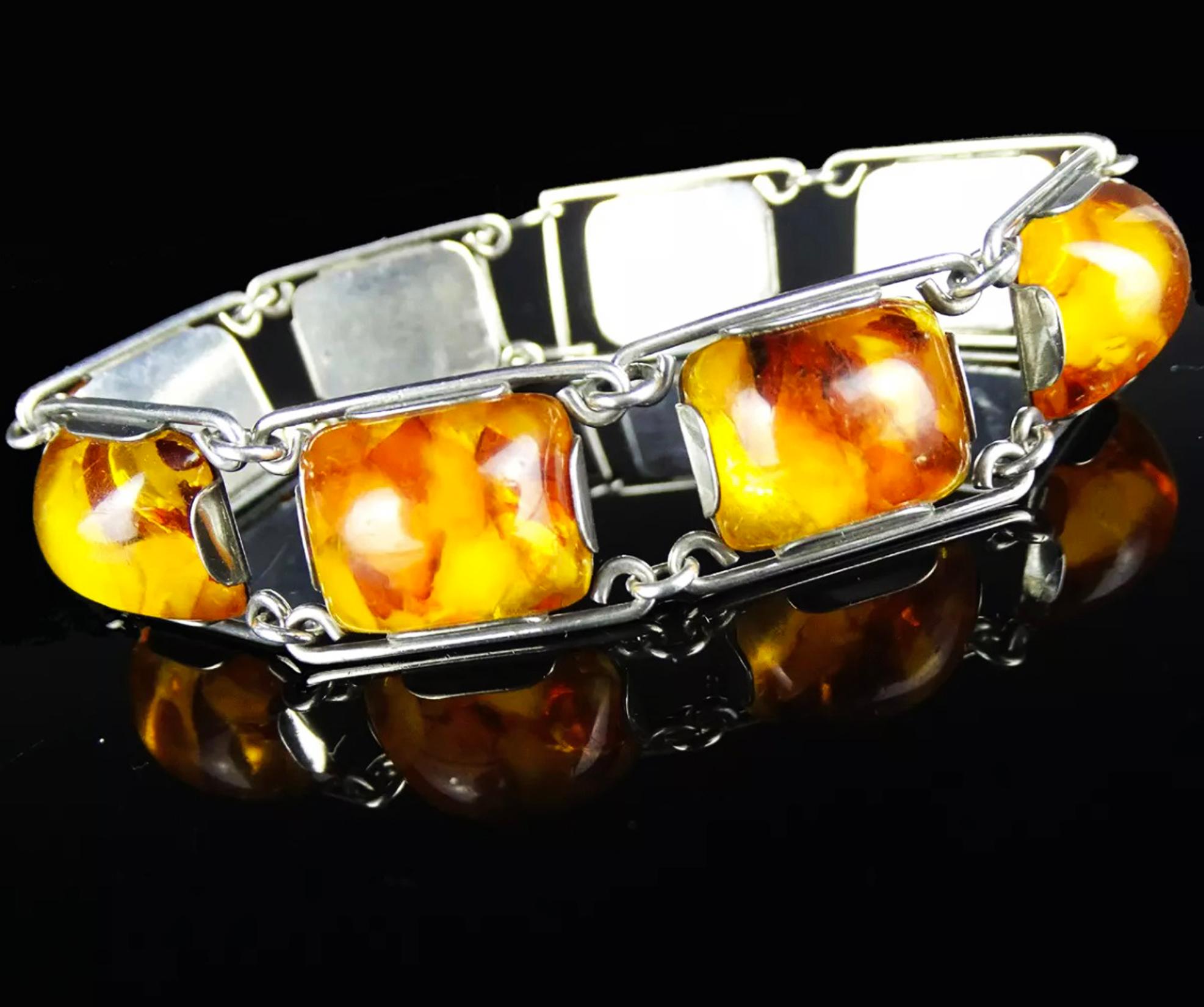 1950’s Baltic Amber and Silver Bracelet, Germany C.1950. Fischland (formerly  Kramer). The bracelet comprising eight cabochon sugar loaf style amber silver set links between link hook fastener. Stamped with Fish mark 835. Length: 7.75 -8.00 inches.