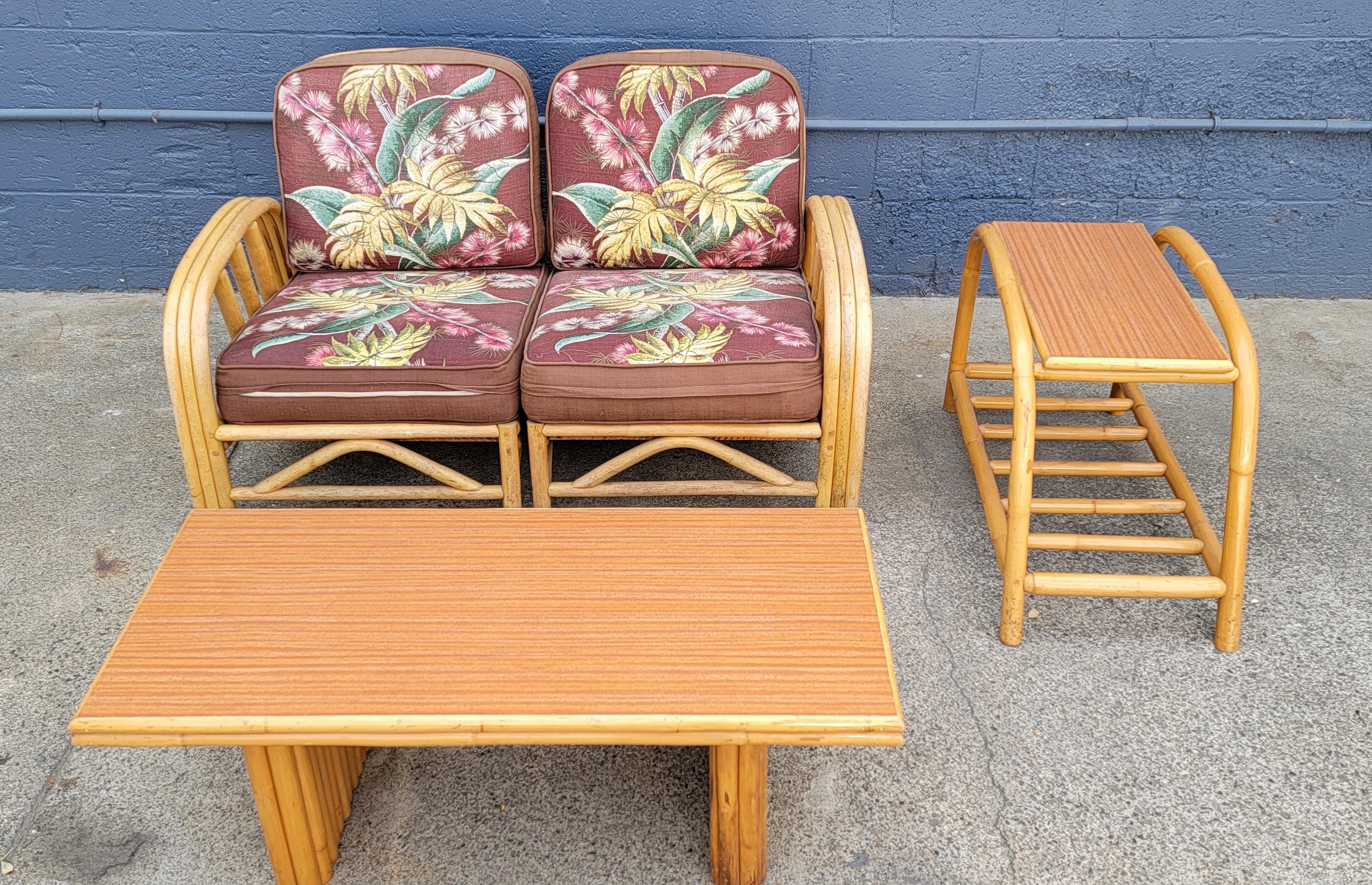 A 1950's bamboo suite consisting of a 2 piece sofa, end table and coffee table. Faux wood Formica tops on tables offer a very durable surface. Made of steamed bamboo, notice no bindings in construction, nothing to unravel. Two tier end or side
