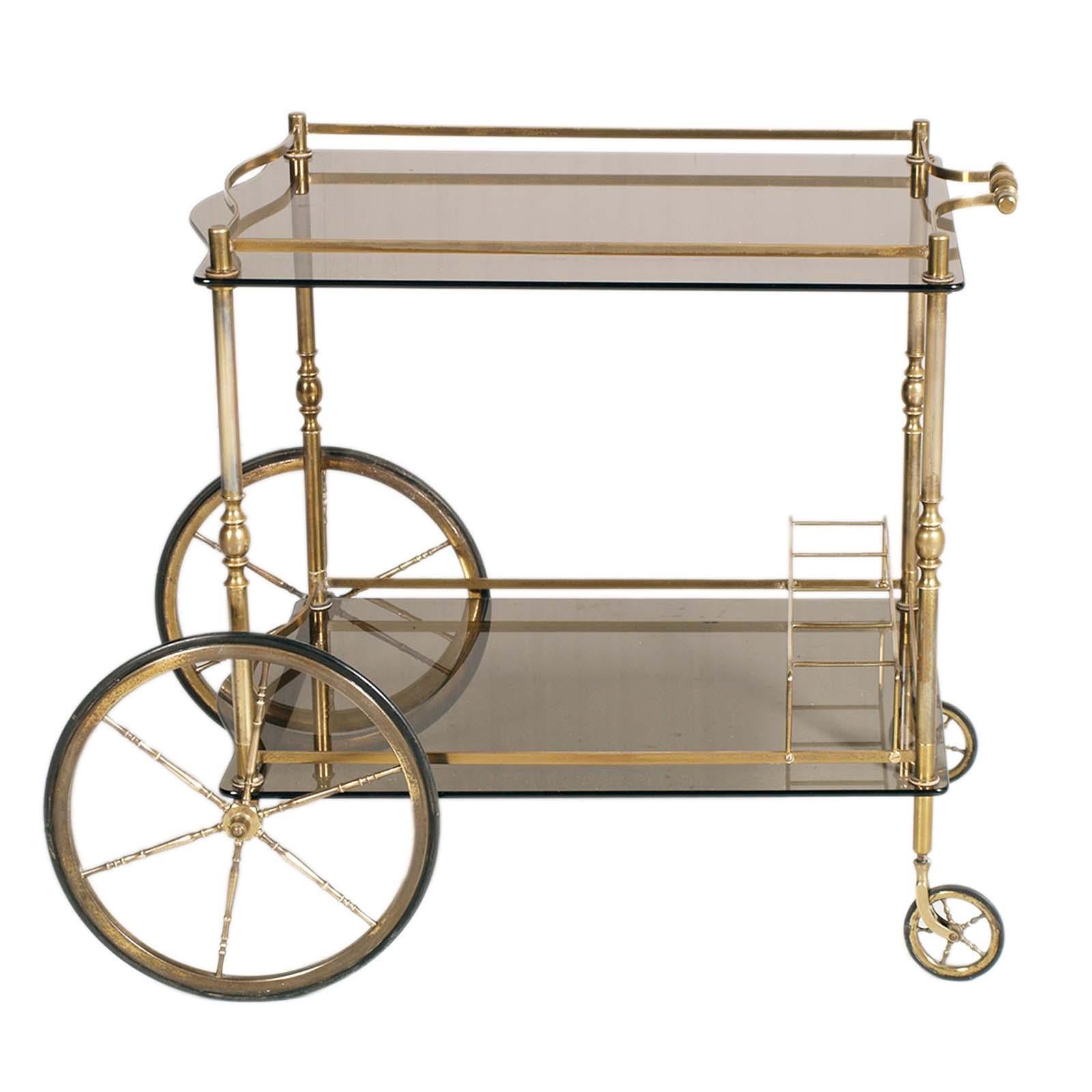 1950s Bar Cart by Aldo Tura for Danieli Hotel Venice in Golden Brass with two Tops Glass Fumè .
This bar trolley is of very classic designs and differs from the later production of the designer


Aldo Tura is an Italian designer, who established his
