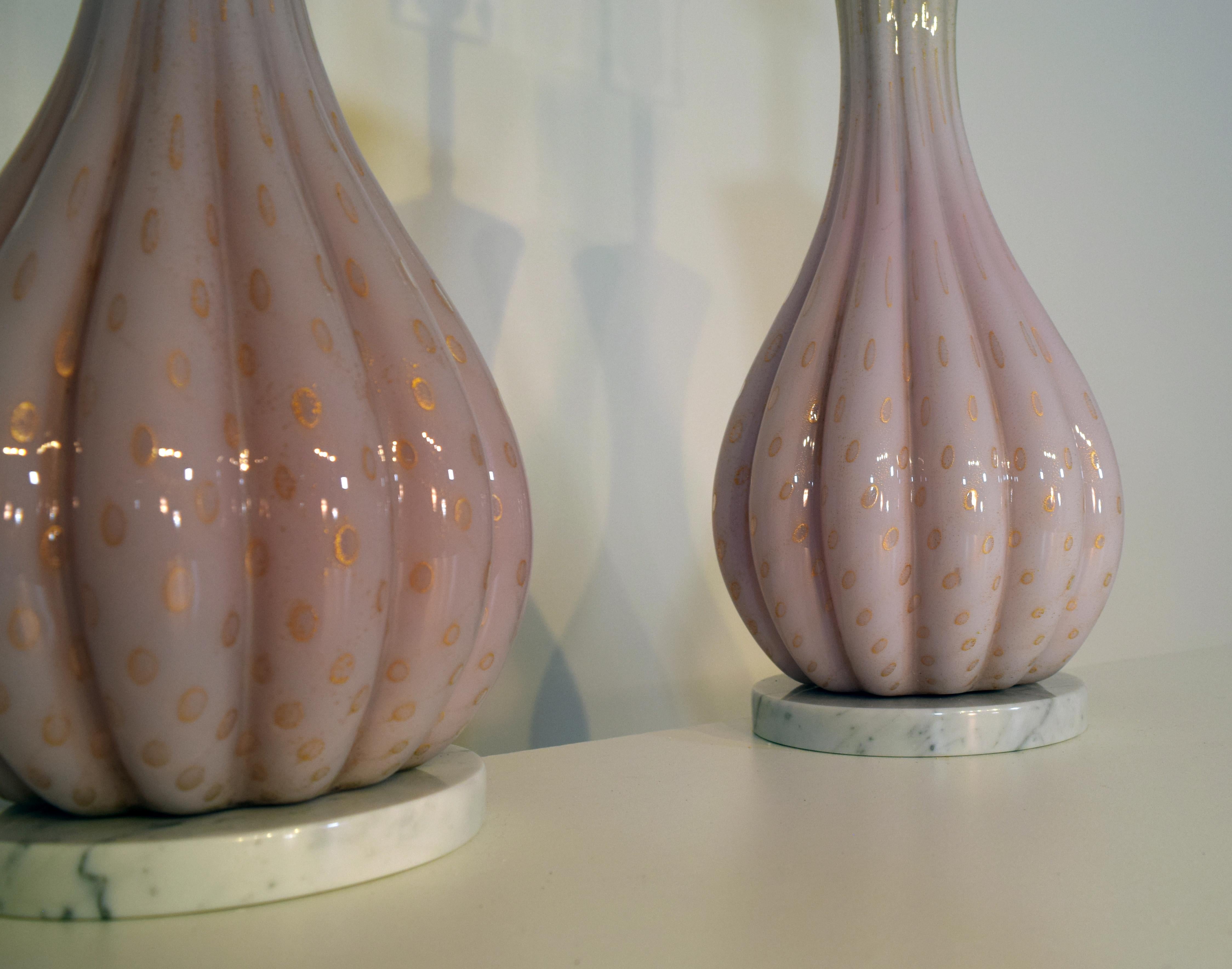 1950s pair of Murano glass lamps featuring a wonderful gold flecking and encased bubble (bullicante) technique on a white background by Alfredo Barbini in a ribbed design. The interior is cased pink glass with the exterior in white and the gold