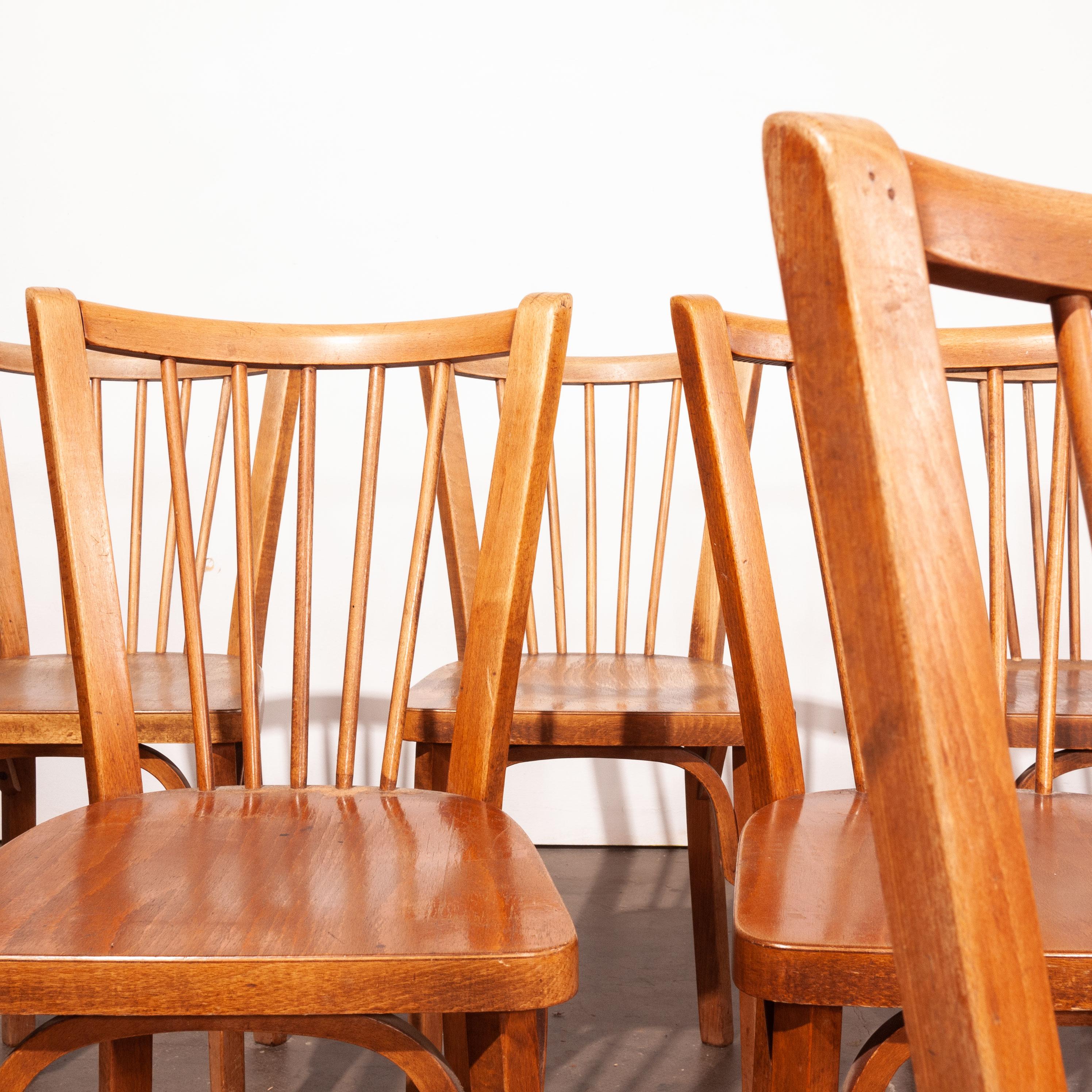 1950's vintage Baumann bistro dining chairs - set of eight. Classic Beech bistro chairs made in France by the maker Joamin Baumann. Stunning original patina and the chairs are stamped by the maker.We service and wax each chair individually before