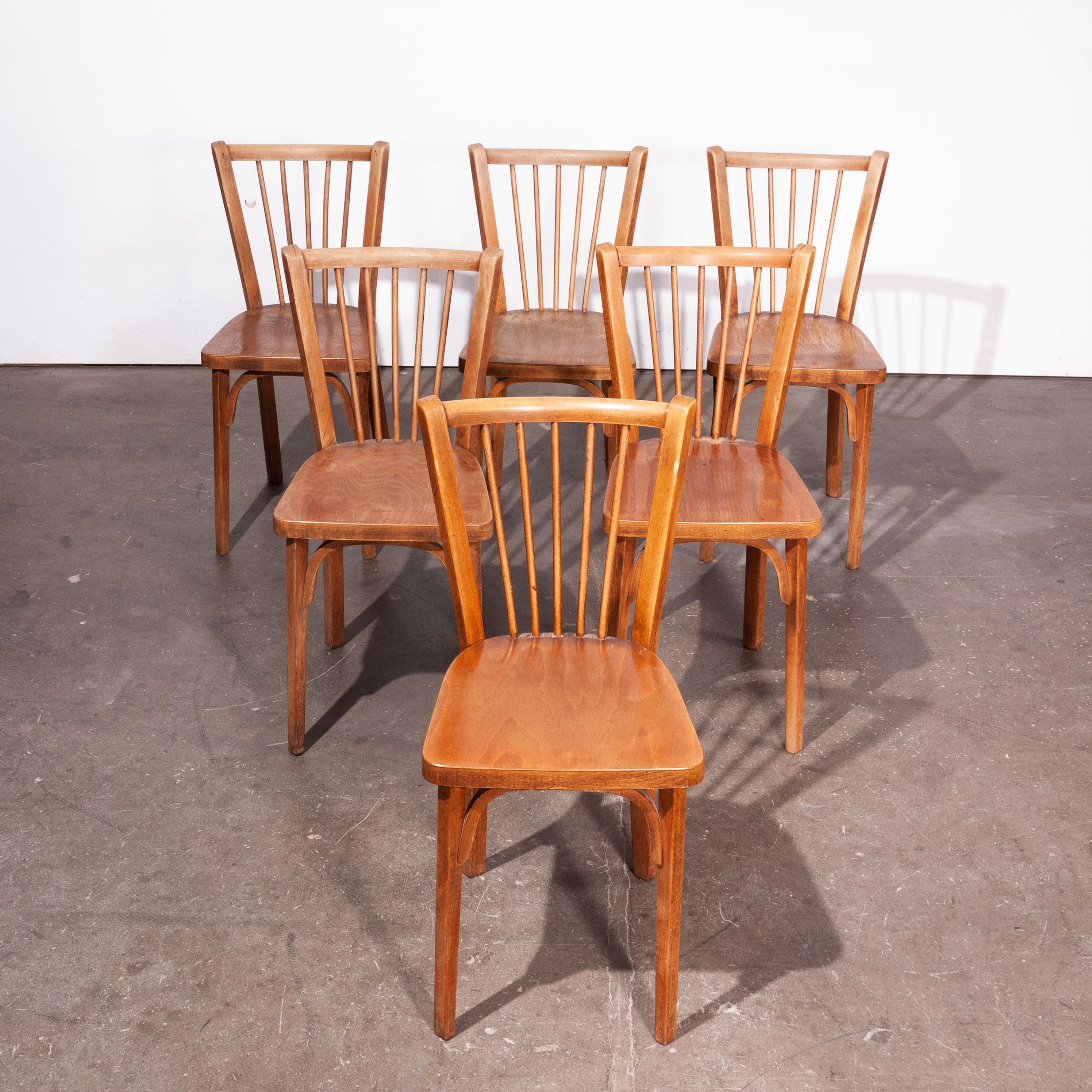 1950s vintage Baumann bistro dining chairs, set of six. Classic Beech bistro chairs made in France by the maker Joamin Baumann. Stunning original patina and the chairs are stamped by the maker. We service and wax each chair individually before they