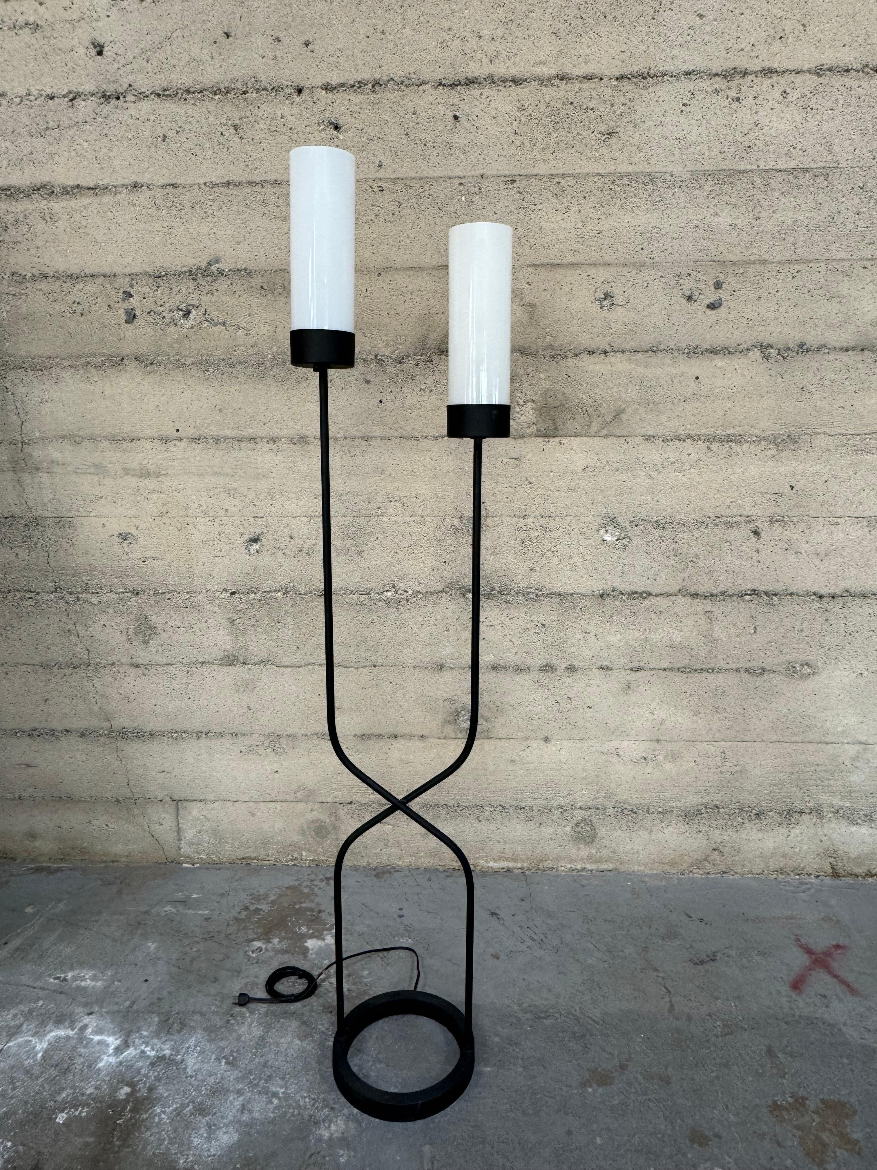 1950s Bay Area designer Robert Bulmore floor lamp in steel and frosted glass, the abstract design is two steel rods criss crossed capped with frosted cylindrical shades resting on his trademark round cast iron base. All of Bulmore's lamps were