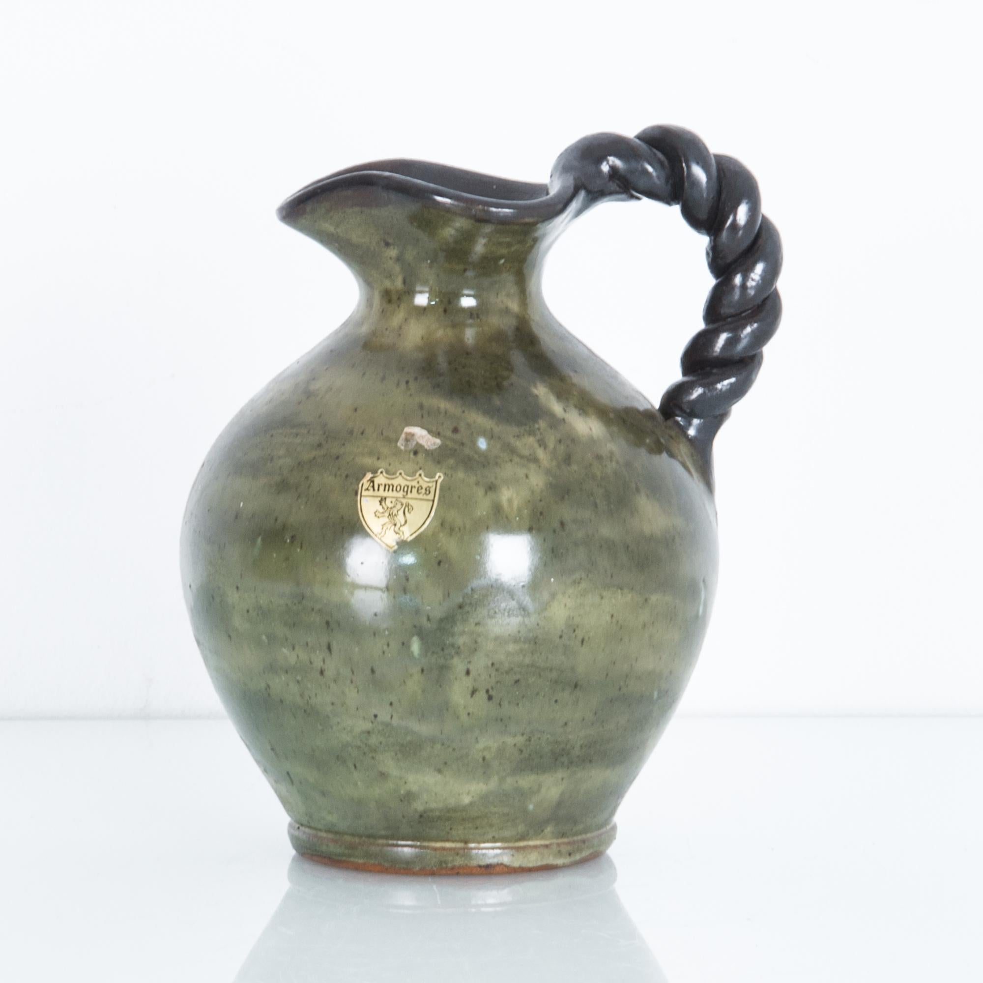 Ceramic stoneware pitcher from Belgium, circa 1950s. These distinctive ceramics pieces were produced in mid-20th century Belgium in the Bouffioulx region. Featuring distinctive twisted handles and graphic textured glazes on simple forms, a local