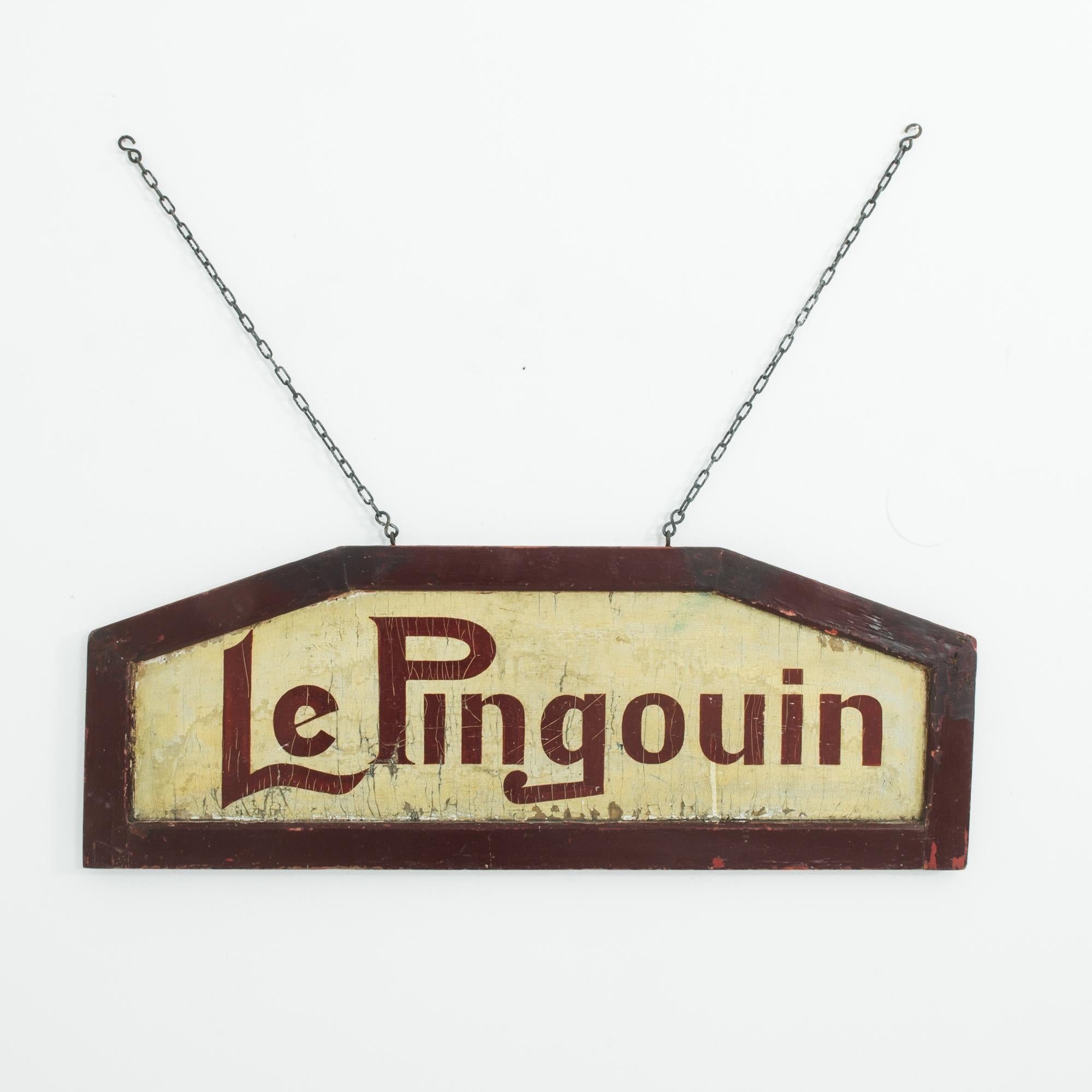 Reminding of summer, warm and sweet, ‘Le Pingouin’ a wooden shop sign from Belgium, circa 1950. Beautifully rendered in a unique calligraphy style, a piece of history capturing the lost art of hand-painted signage and the nostalgic style of 1950s