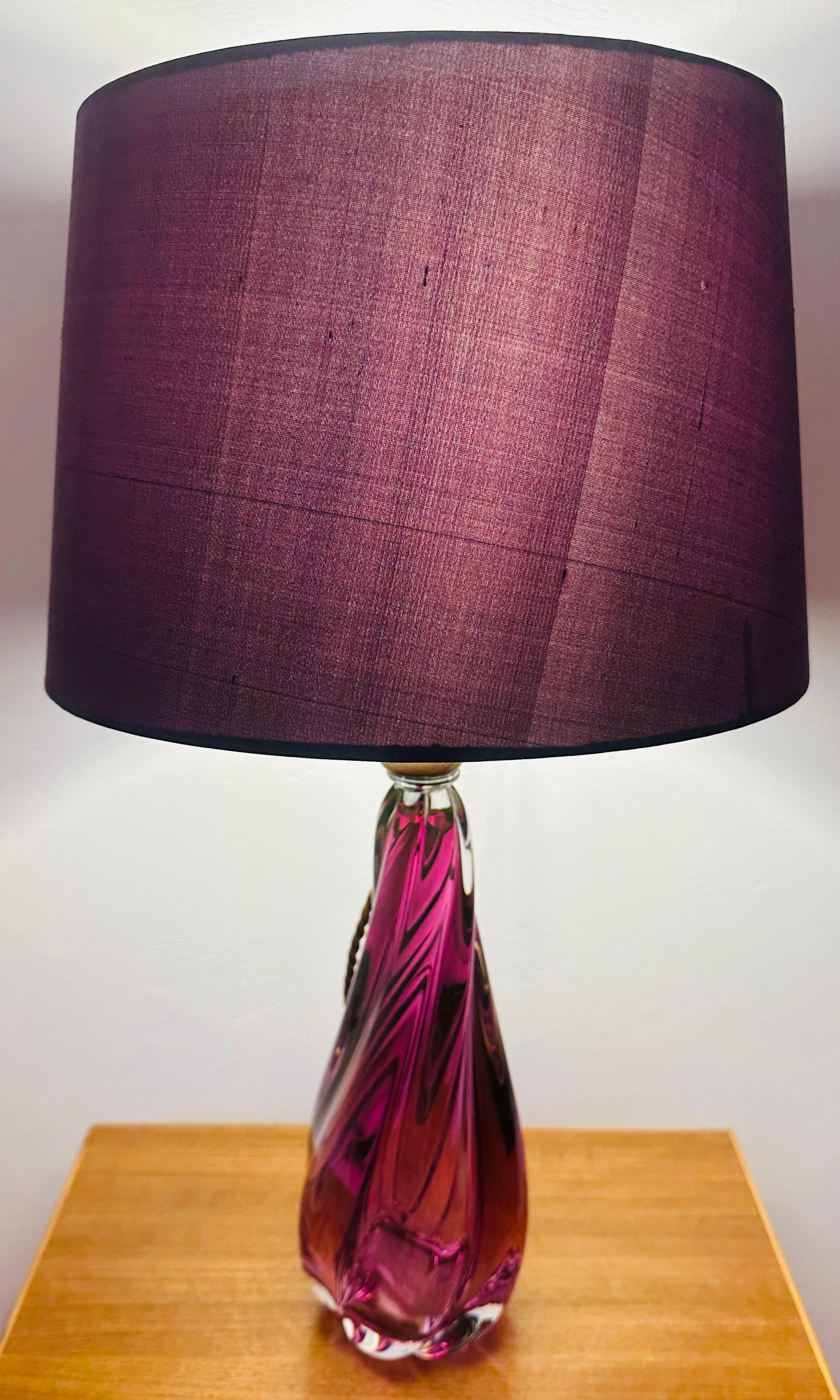 1950s Belgium Val Saint Lambert purple and clear crystal glass table lamp with a turned tapering flowing swirled form. The lamp is fitted with an antique brass mounted socket with an on/off switch fitted within it.  This can be accessed from