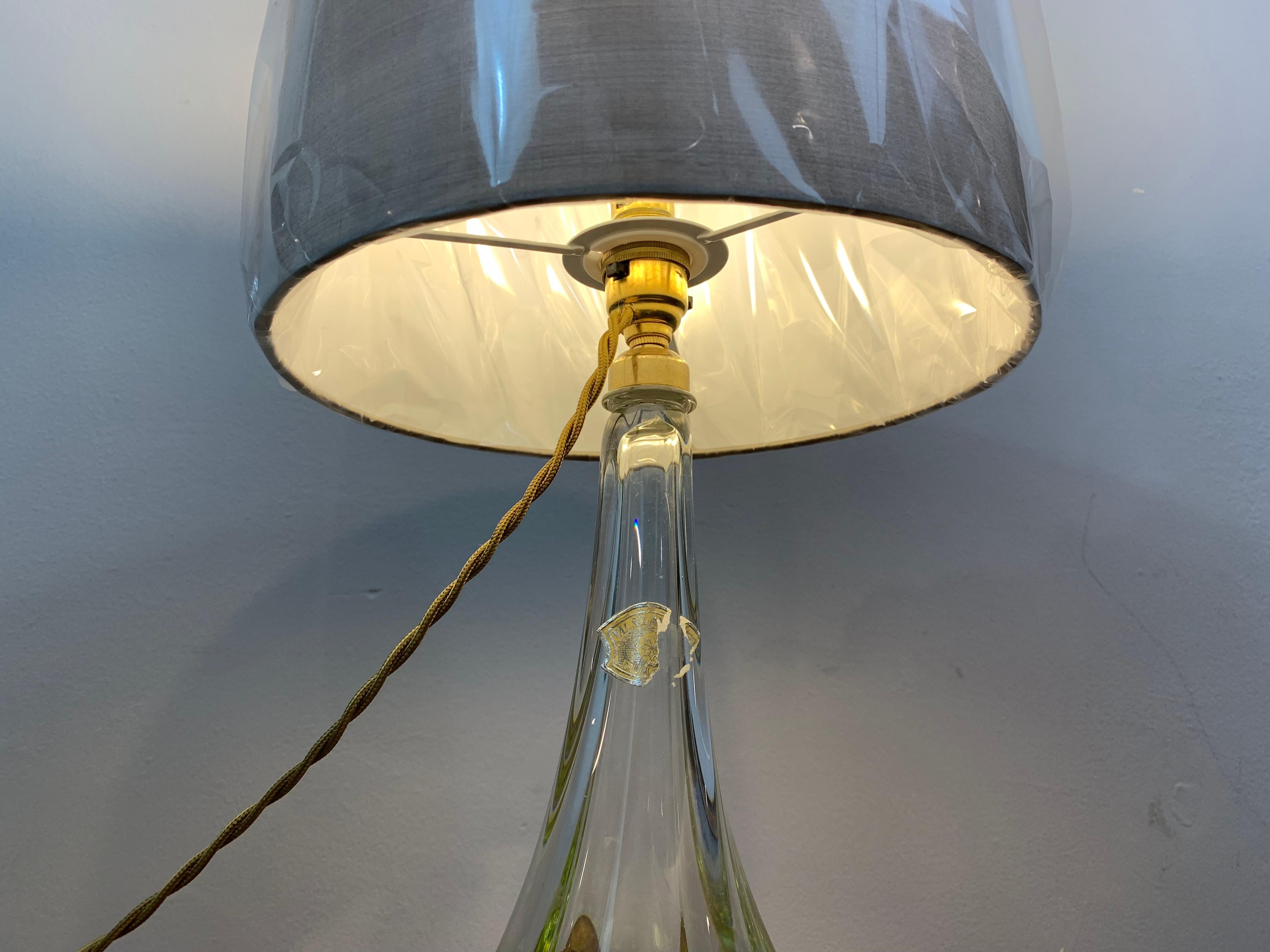 1950s Belgium Val St. Lambert hand blown lime green and clear glass crystal table lamp which includes part of the original manufacturer's label. The lamp is hollow inside and features incised deep grooves running vertically to create a scalloped