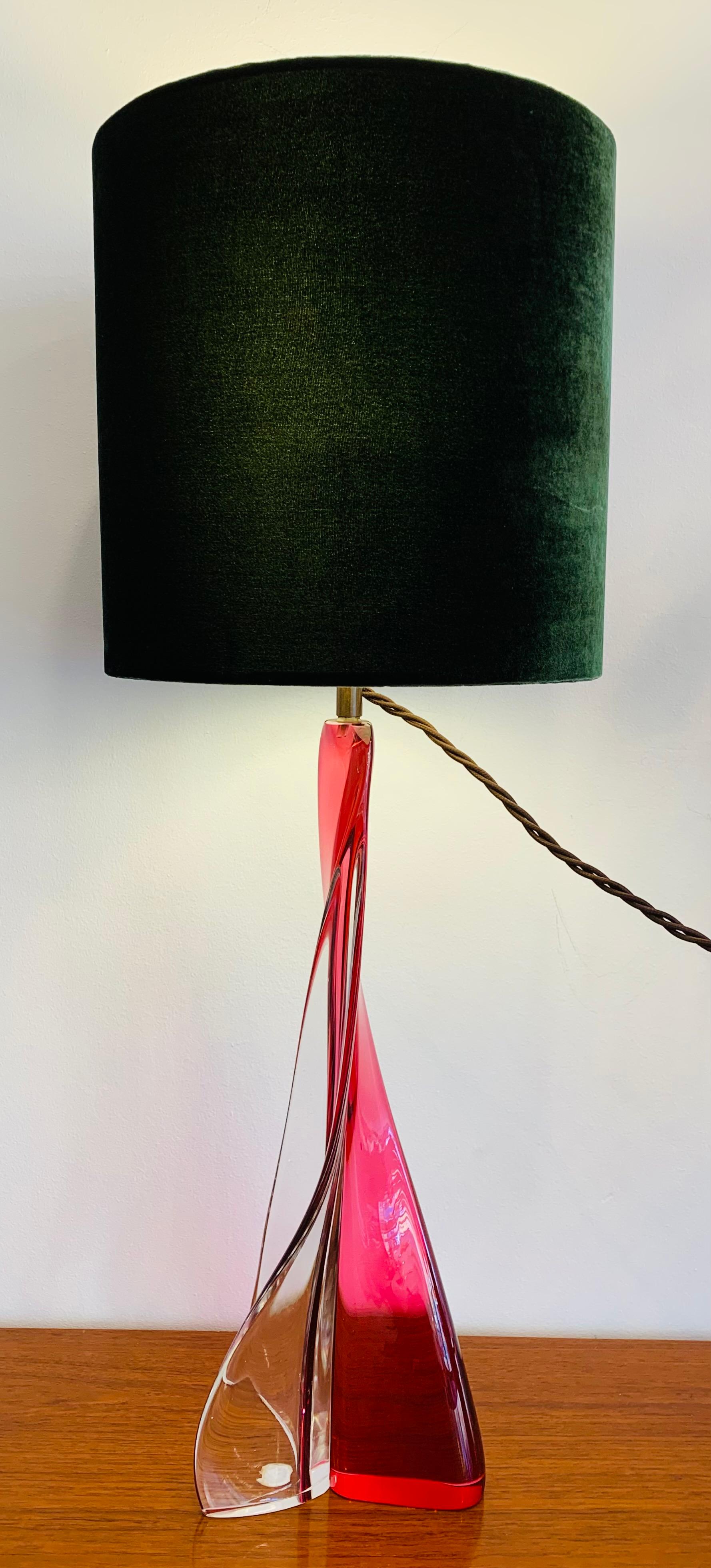 An unusual design and construction by Belgium glassmaker Val St Lambert from a single piece of clear glass shaped in a crescent moon with a thicker piece of pink glass fused to it creating a tripod base. A truly stunning and beautiful lamp with a