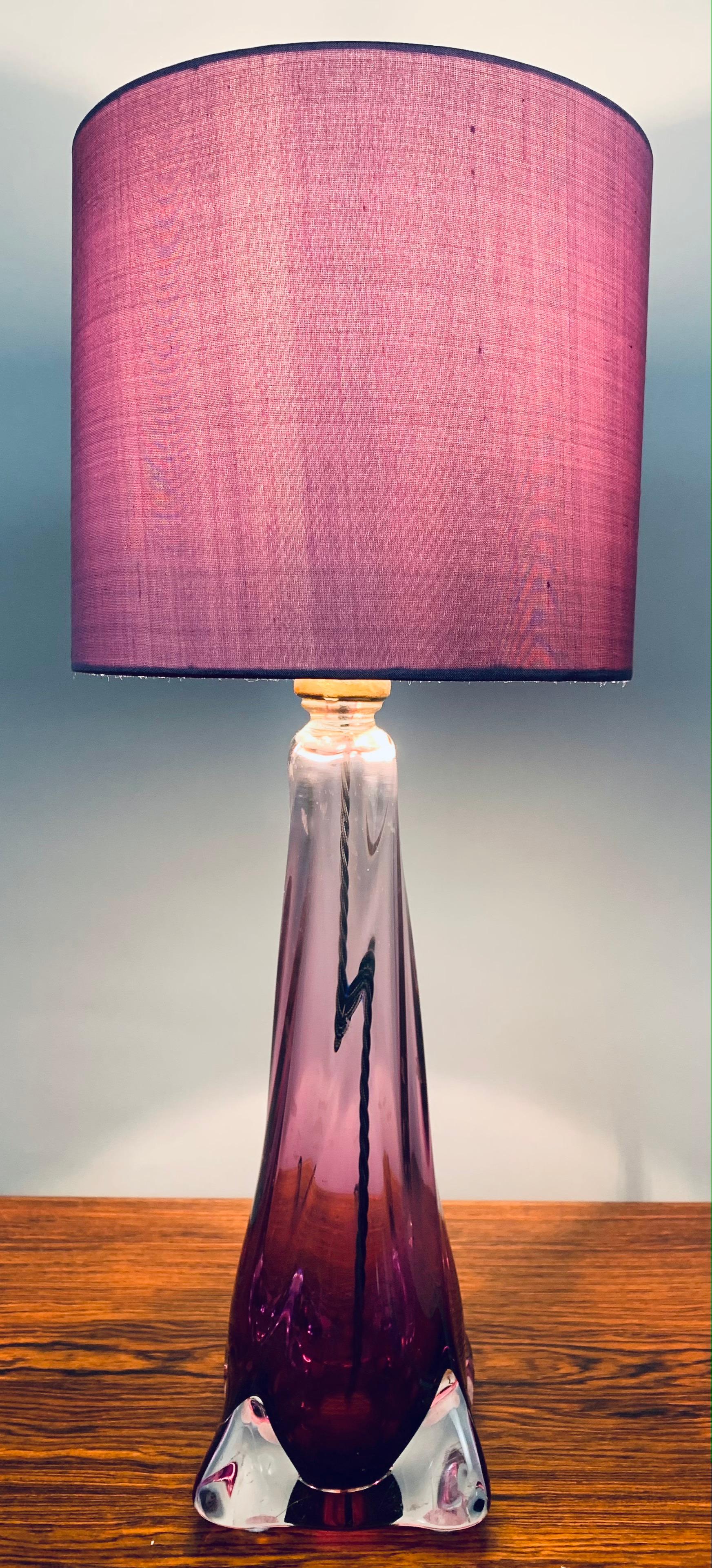 1950s mid century Belgium Val Saint Lambert, hand blown, purple and clear crystal glass, table lamp which includes a new purple silk shade. The lamp is a striking deep purple towards the base becoming clearer towards the top. Each corner of the