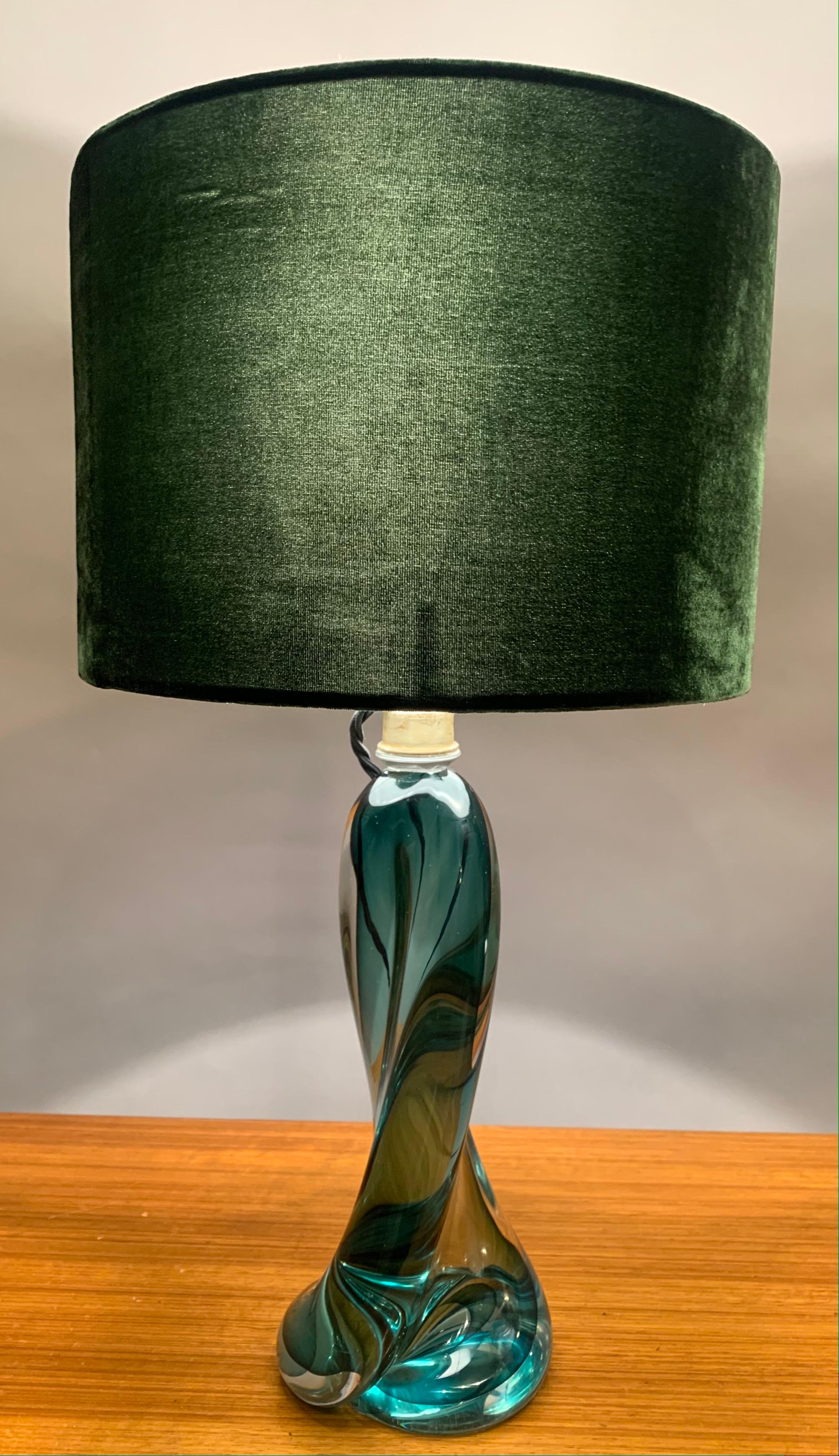 A 1950s, Belgium, Val Saint Lambert, hand-blown, dark green crystal table lamp base, encased in clear glass, which also includes the shade. This solid glass lamp is heavy and features a turned tapering swirled design which widens towards the base.