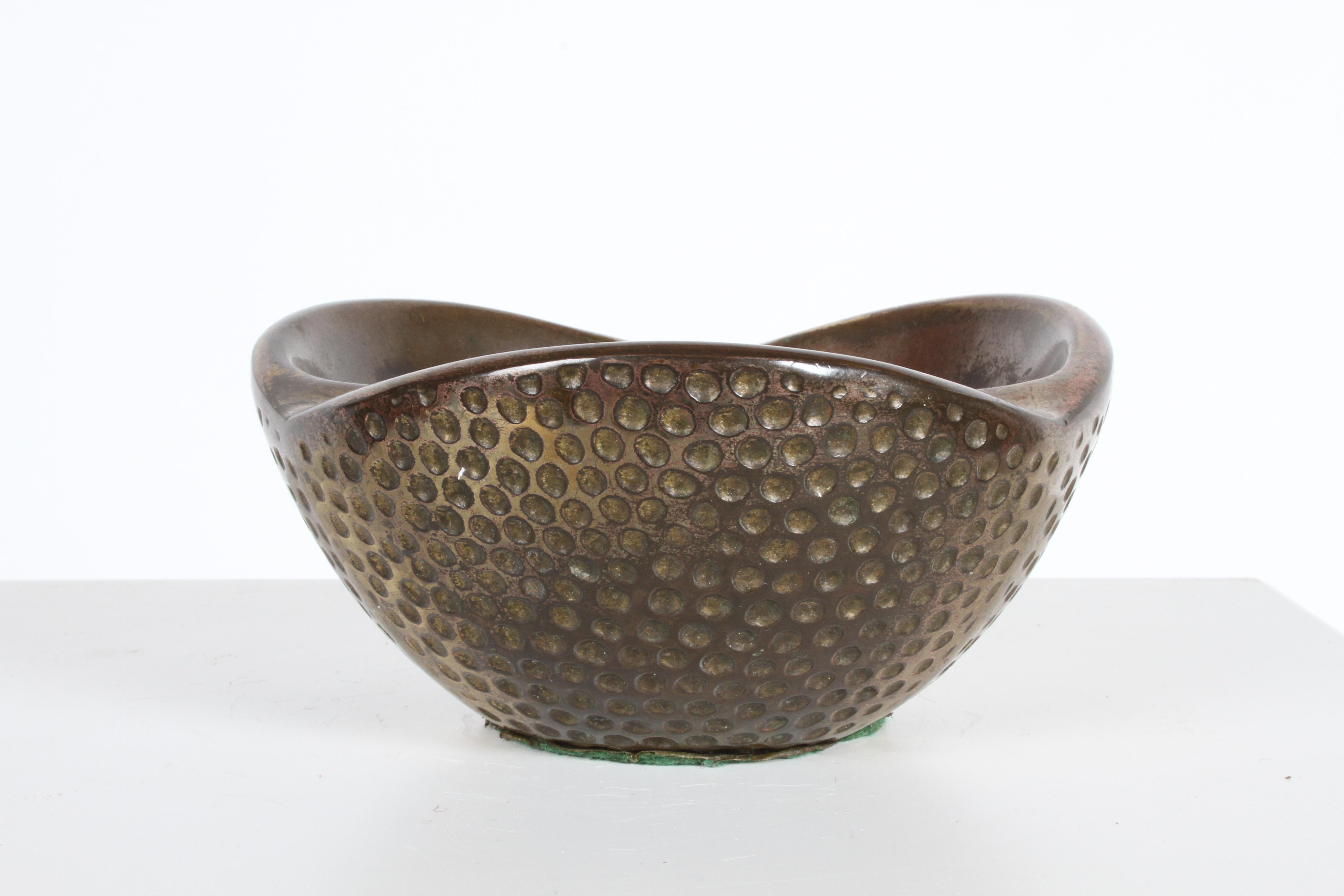 Sculptural brass ash tray designed by Ben Seibel for Jenfred-Ware. Biomorphic shape with golf ball like hole pattern. Patina from use.