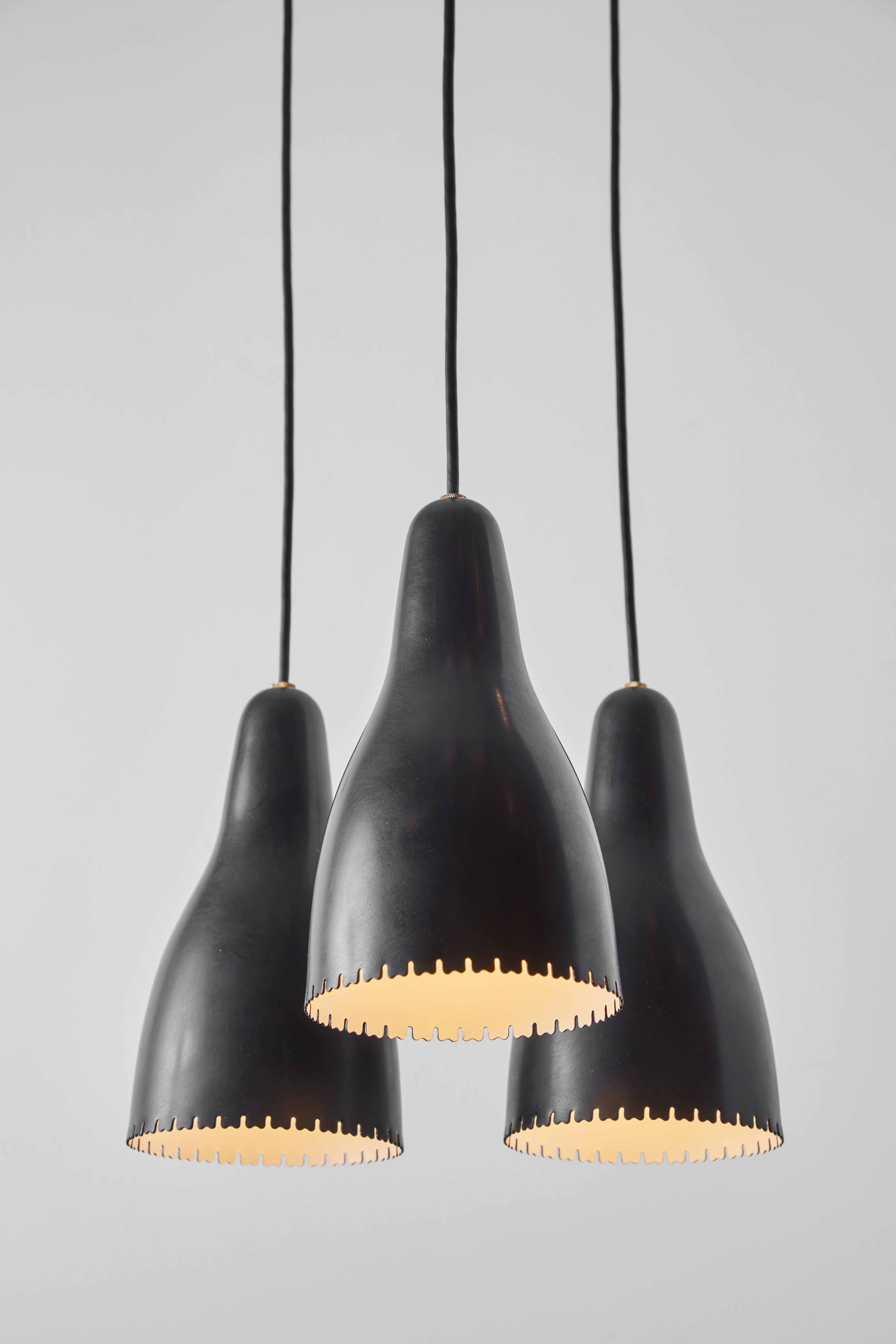 1950s Bent Karlby 3-shade chandelier in black painted metal & brass for Lyfa. Executed in architecturally cut and elegantly shaped black painted metal shades with brass hardware, Denmark, circa 1950s. A quintessentially Danish Modern chandelier by a