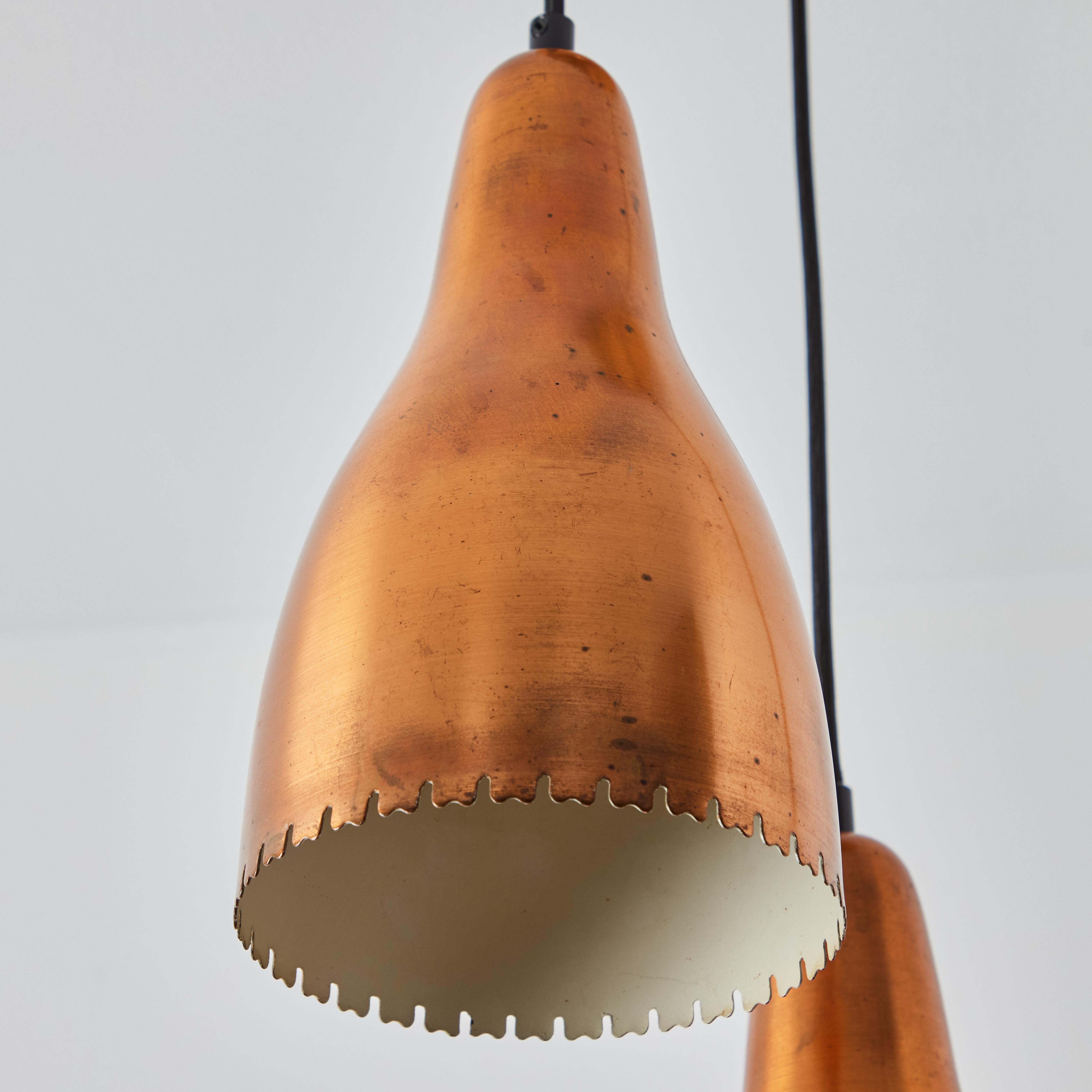 1950s Bent Karlby 3-Shade Chandelier in Copper for Lyfa. Executed in architecturally cut and elegantly shaped copper shades with an attractive patina, Denmark, circa 1950s. A quintessentially Danish Modern chandelier by a master Swedish designer