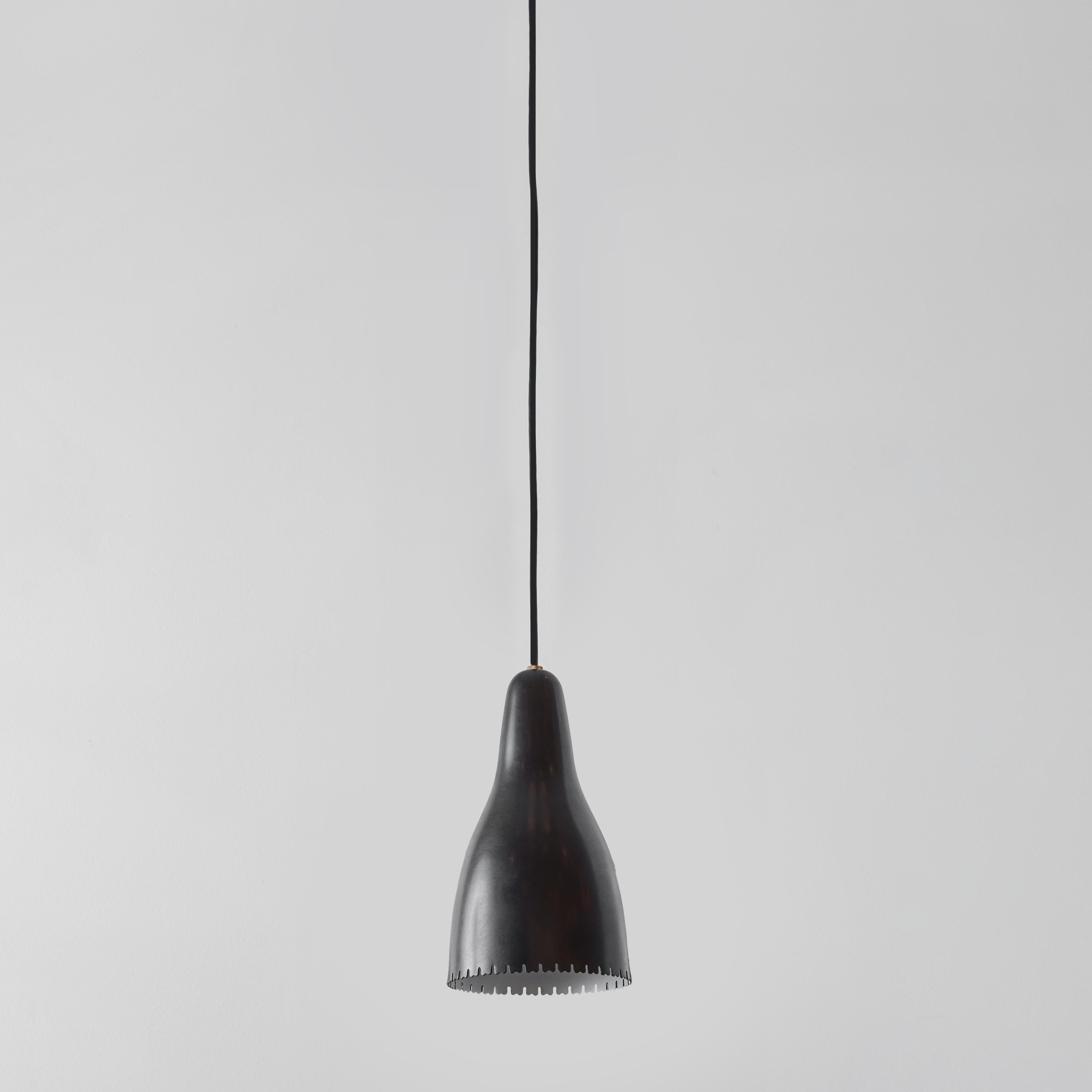 1950s Bent Karlby Black Painted Metal & Brass Pendant Lamp for Lyfa. Executed in architecturally cut and elegantly shaped black painted metal shades with brass hardware, Denmark, circa 1950s. A quintessentially Danish Modern pendant by a master