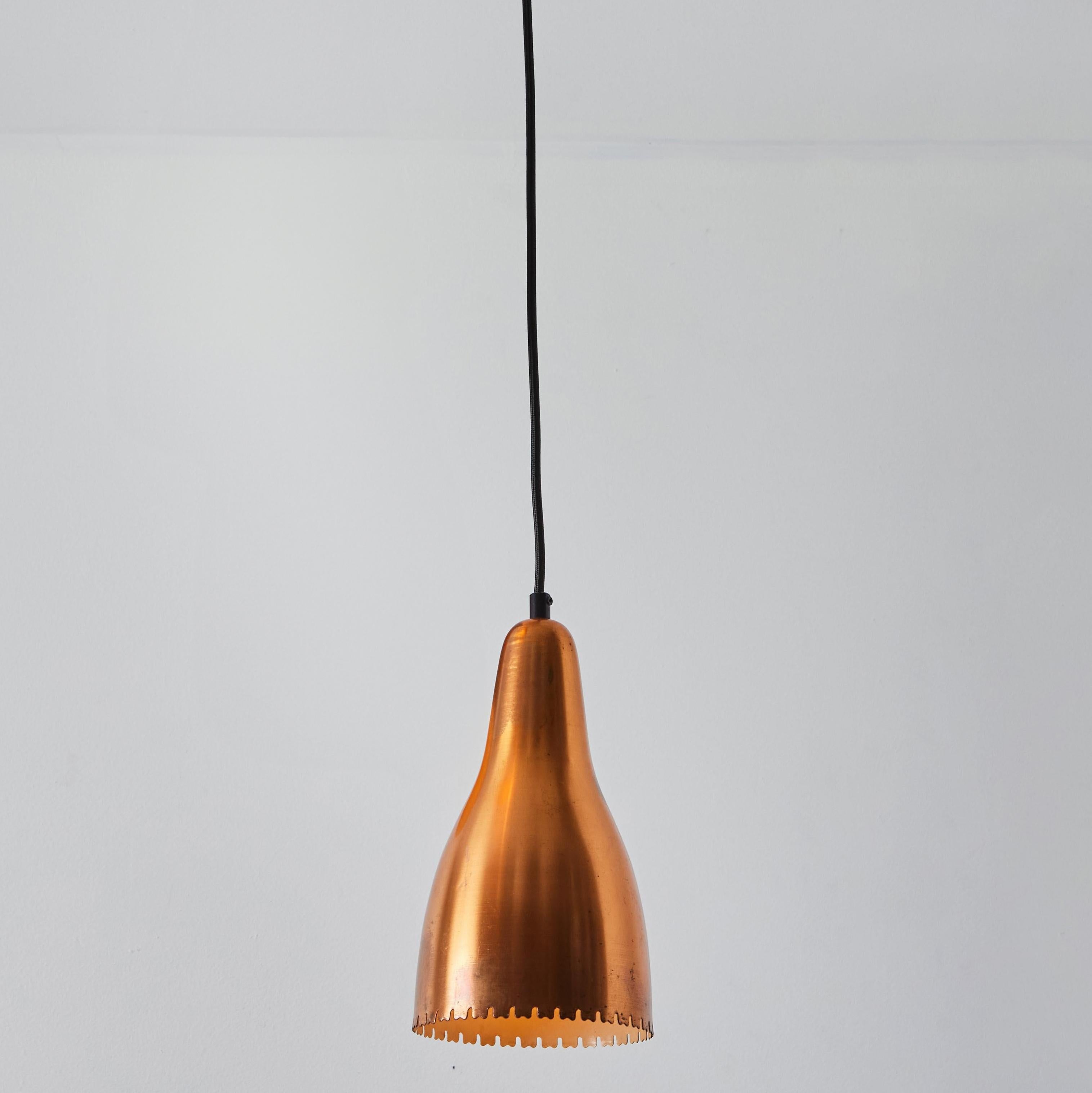 1950s Bent Karlby Perforated Copper Pendant for Lyfa. Executed in architecturally cut and elegantly shaped copper shades with an attractive patina, Denmark, circa 1950s. A quintessentially Danish Modern pendant by a master Swedish designer whose