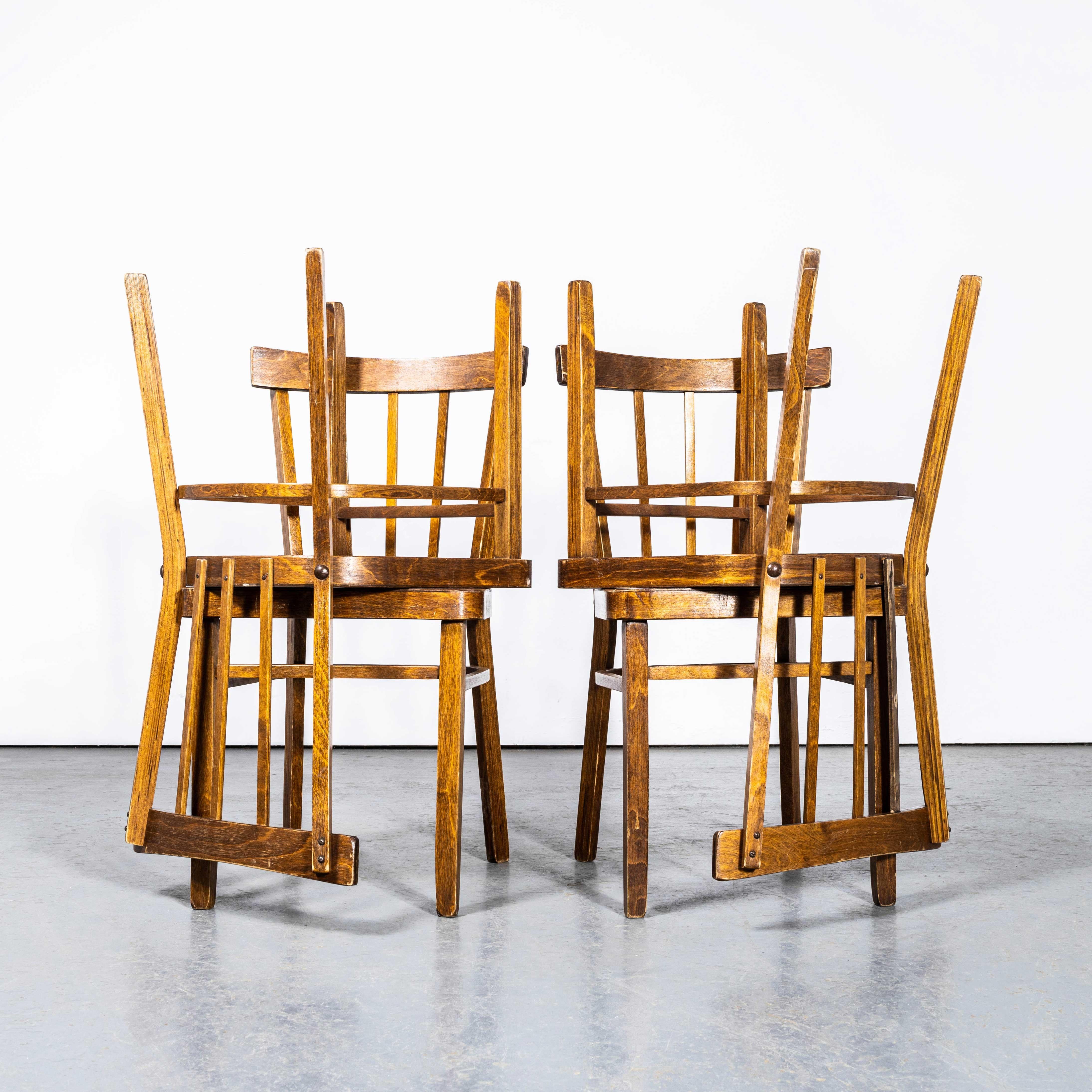 1950's Bentwood Debrecen Simple Stick back Dining Chairs - Set Of Four. 

It is hard to be precise about the origin of these chairs as they are not labelled, but we do know this is a classic 50's shape produced by Debrecen. Debrecen produced