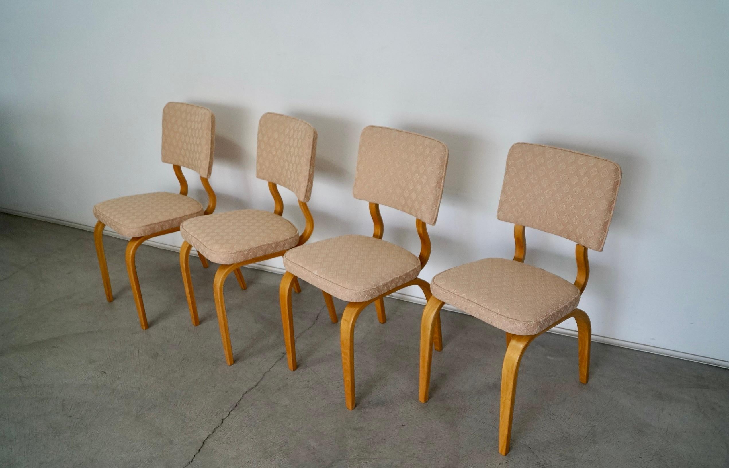 Vintage original 1950s Mid-Century Modern dining chairs for sale. They have a bentwood frame in ash that has been refinished in natural ash. They have been reupholstered in new fabric and foam. The fabric is a soft pale pink with white textured