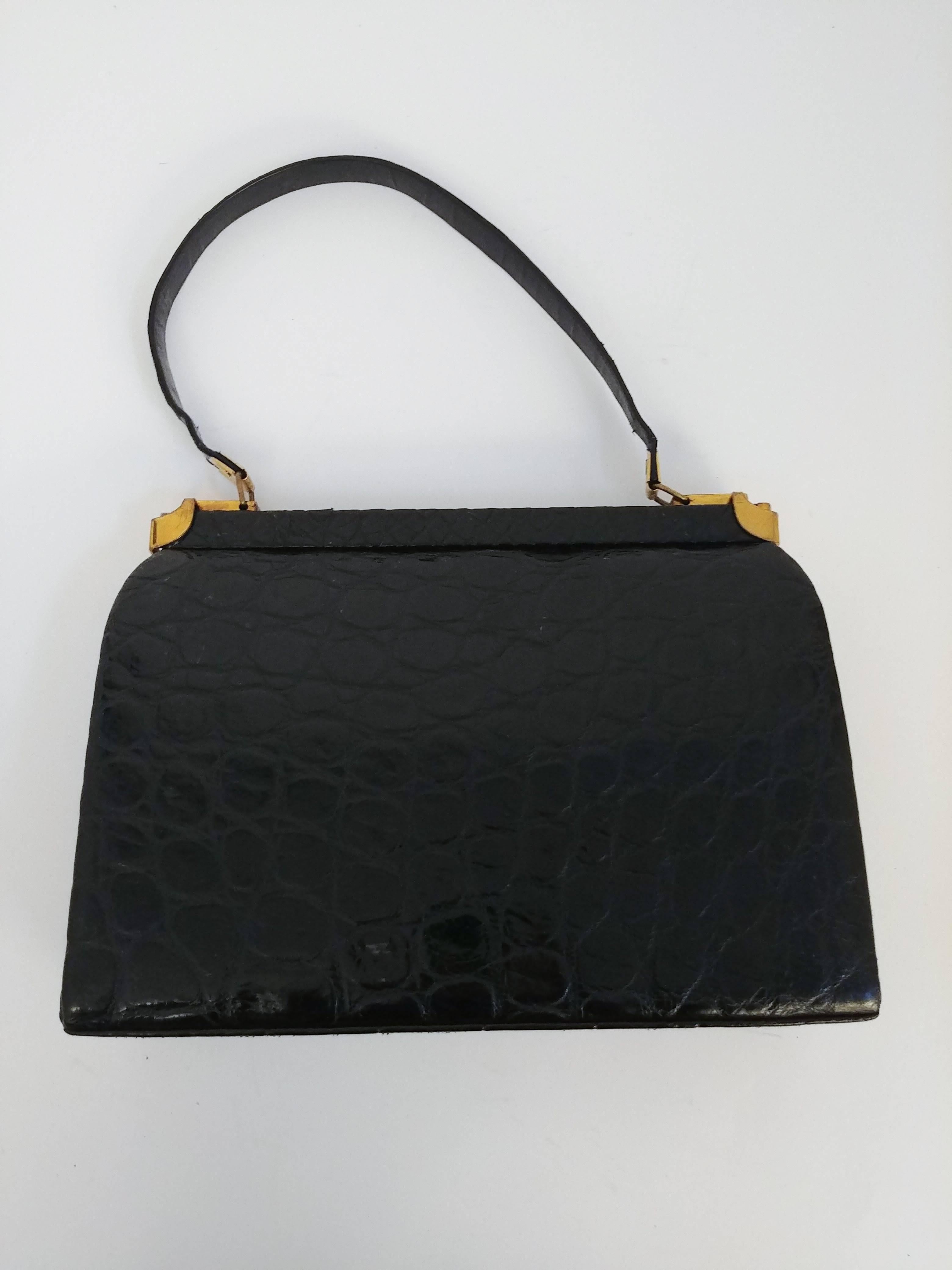 1950s Black Alligator Handbag. Gold hardware closures flip open at sides for extra security. Leather interior. 