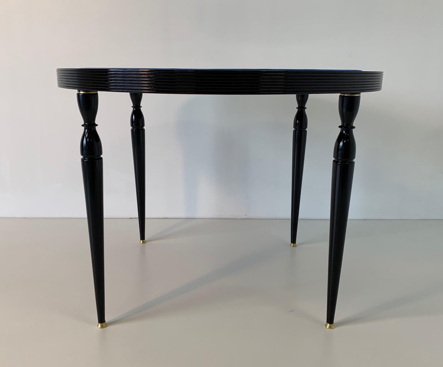 Unique Italian game or card table from the 1950s in precious wood with black structure and brass details with swivel top in blue velvet.
Completely restored.