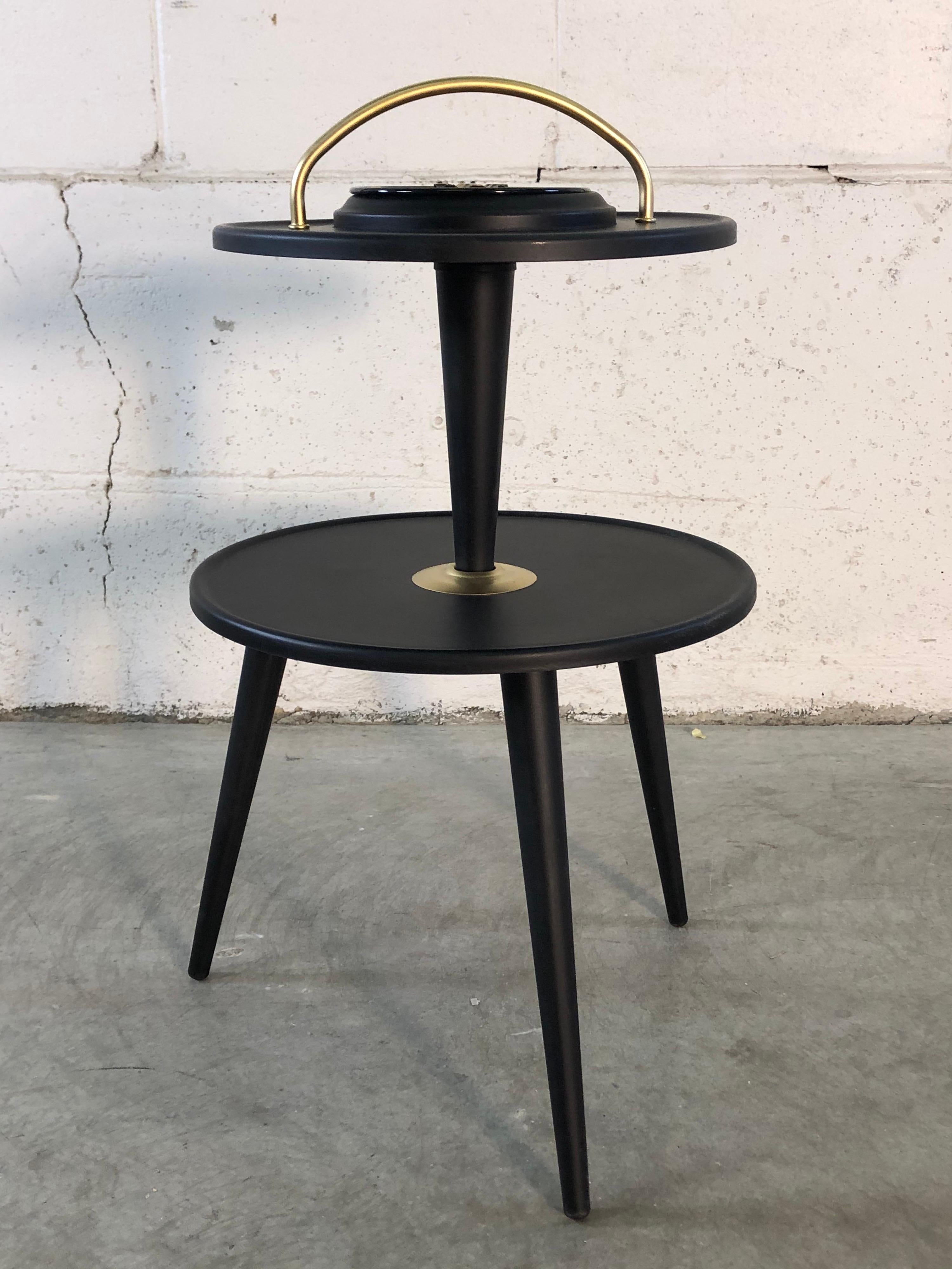 Vintage 1950s round handled black wood ashtray stand. The stand has been newly refinished and repainted. Comes with the enamel ashtray insert. No marks.
