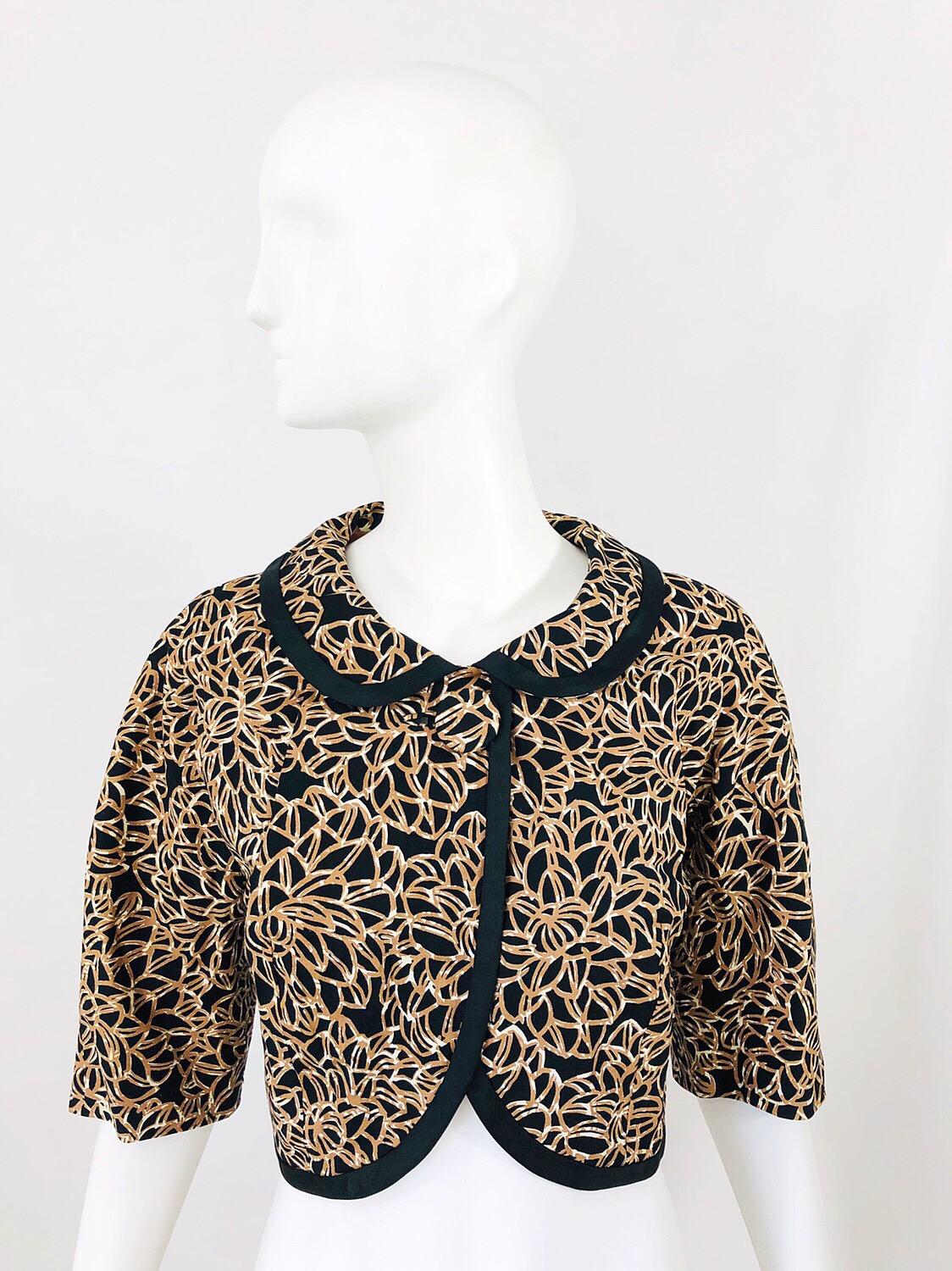 Chic late 1950s black, brown and ivory abstract flower print 3/4 sleeves cropped silk jacket! Single large silk covered button at top center neck. Peter Pan style collar. Can easily be dressed up or down. Great with jeans, trosuers, a skirt, shorts,