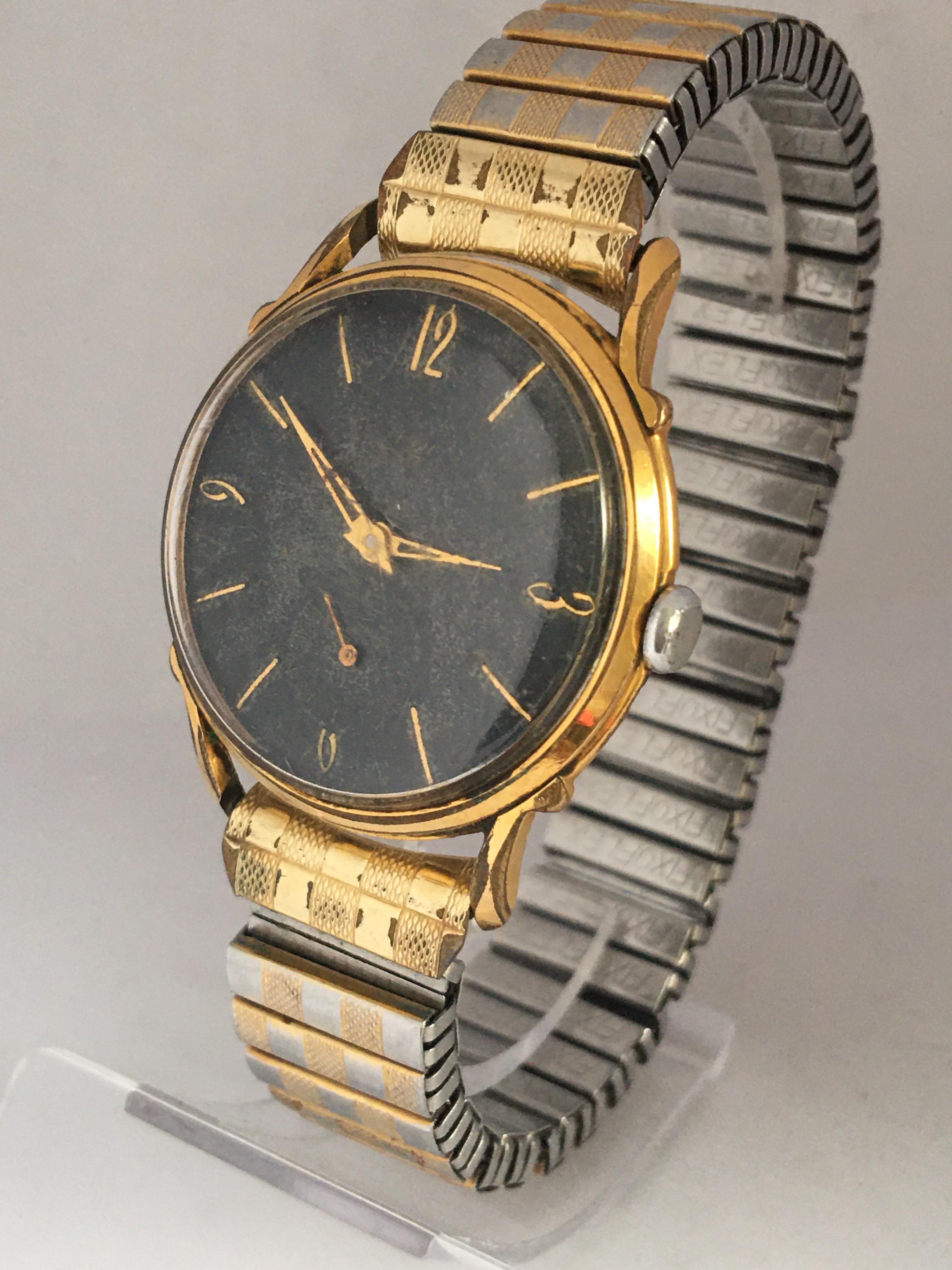 This charming pre-owned vintage manual winding watch is working and it is ticking well. Visible Scratches on the glass and on the Bessel as shown. The watch case and bessel are a bit tarnished as shown. Its 6.5 inches flexible bracelet has some