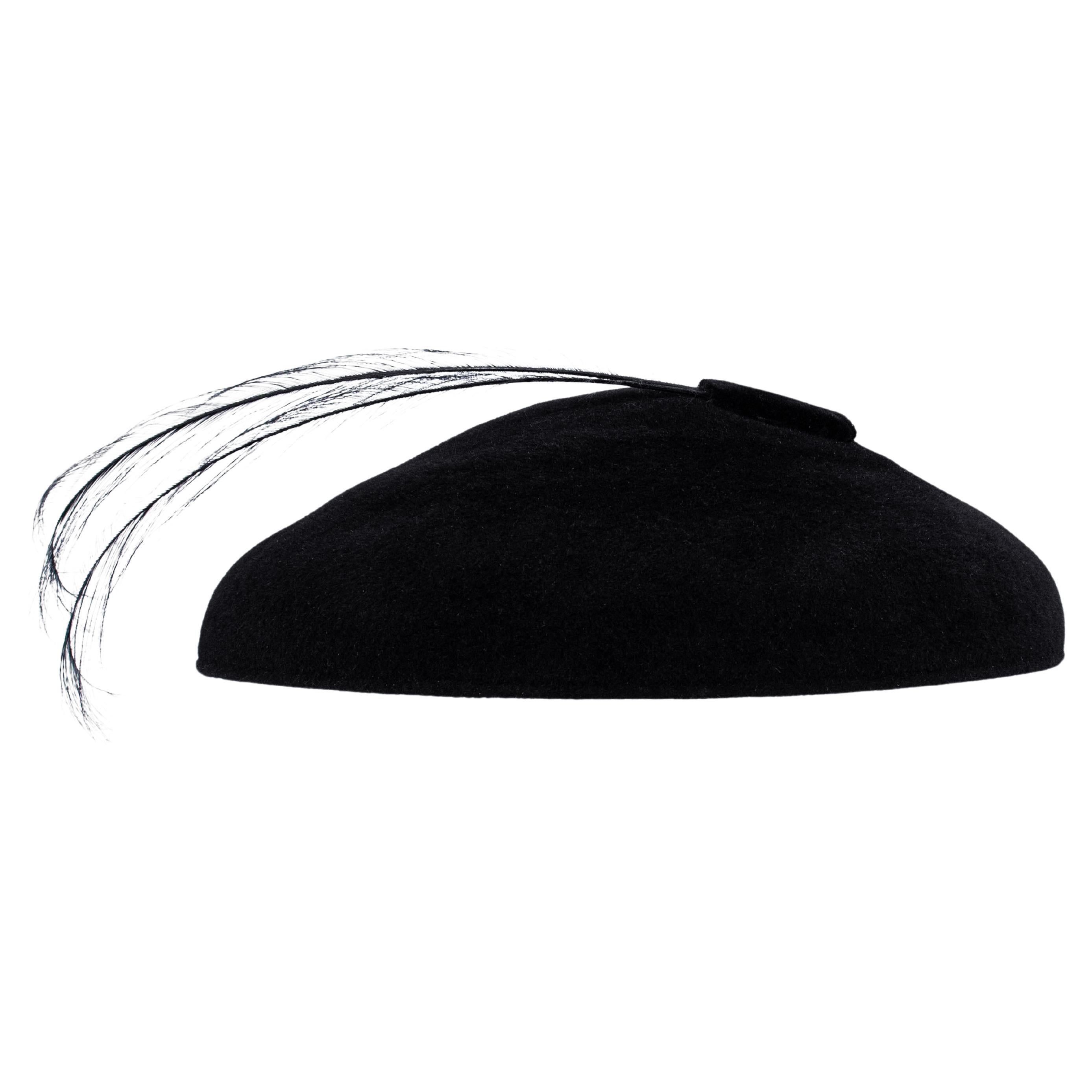 Striking in silhouette and timeless in appeal, this 1950's black felt saucer hat by Nina of New York channels vintage drama with a modern twist. Sculpted from rich black felt, it's structured, minimalist form sits confidently atop the head, while