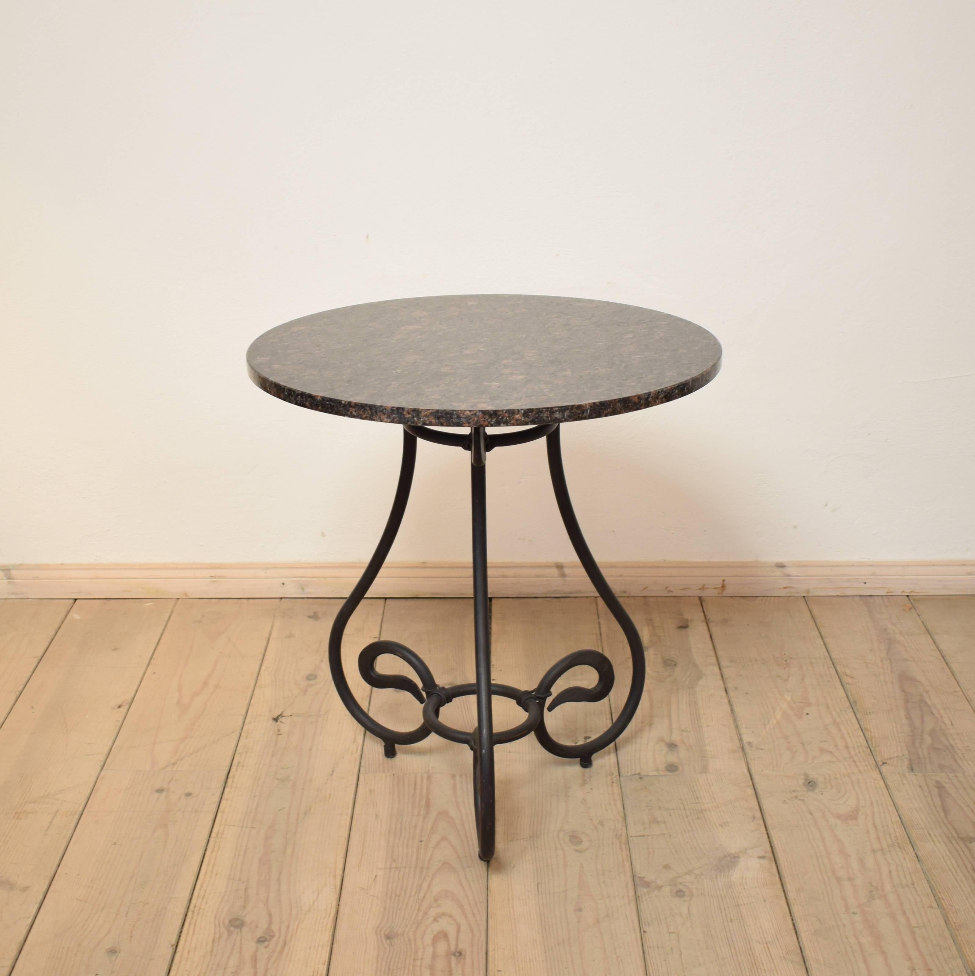 This forged iron side table was made in the 1950s by a German Blacksmith in South Germany. It is very nice made and it has got a granite top.
A beautiful and elegant piece which fits to the most interiors.