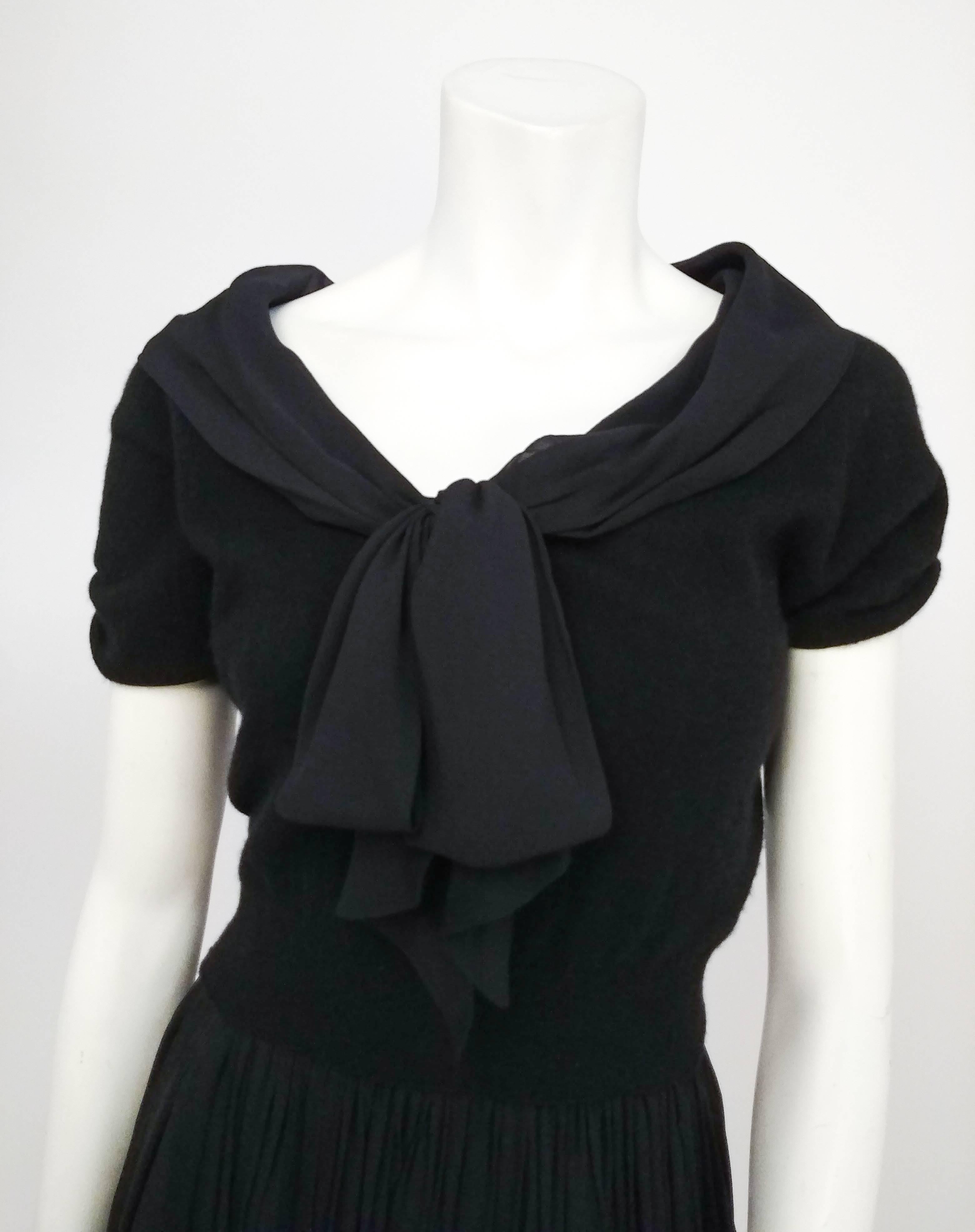 1950s Black Knit Top & Chiffon Skirt Two Piece Set. Adorable two piece set with sweater knit top featuring short gathered sleeves and chiffon tie front collar. Gathered chiffon skirt with natural waistline zips at side.