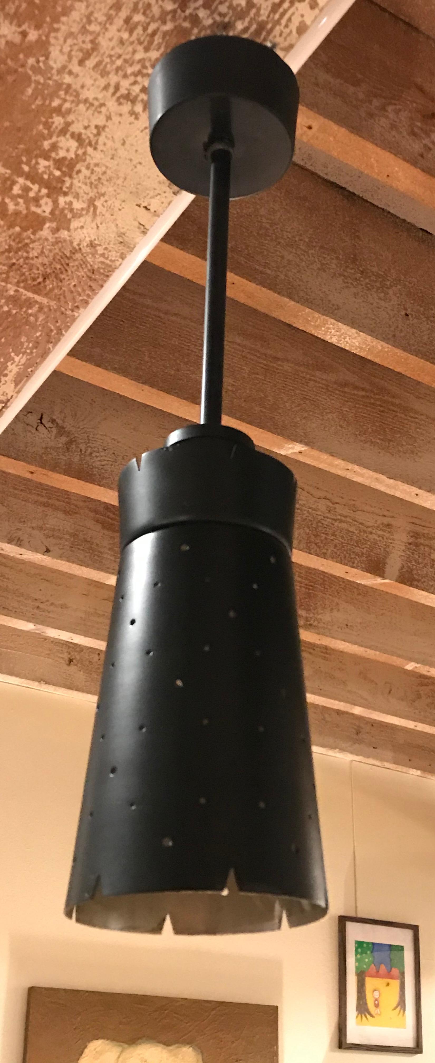 This pendant light features a starry cone made of black lacquered steel.
The light pierces from the stars and gives a festive atmosphere.