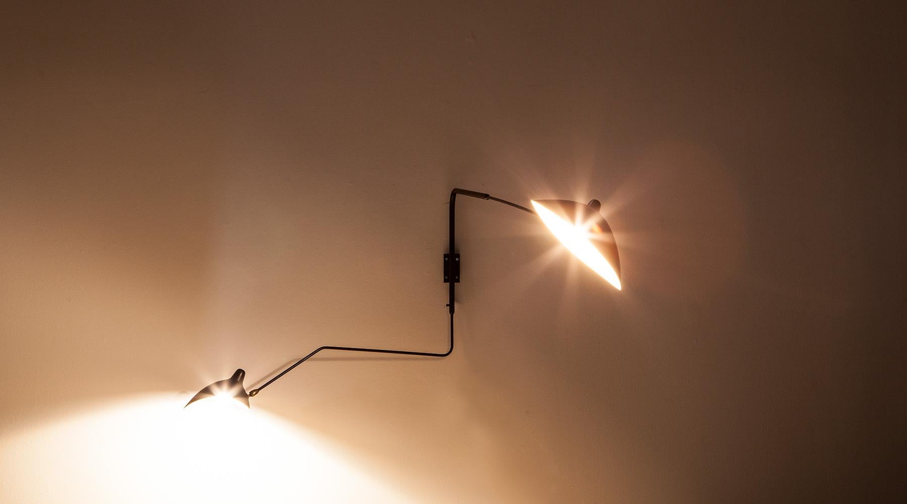 Wall Lamp, black metal by Serge Mouille, France, 1953.

A fantastic example of the worldwide famous lamp model by Serge Mouille. The arms' shape elegantly stretches out in two directions lending it a graphic and fragile look. Manufactured by