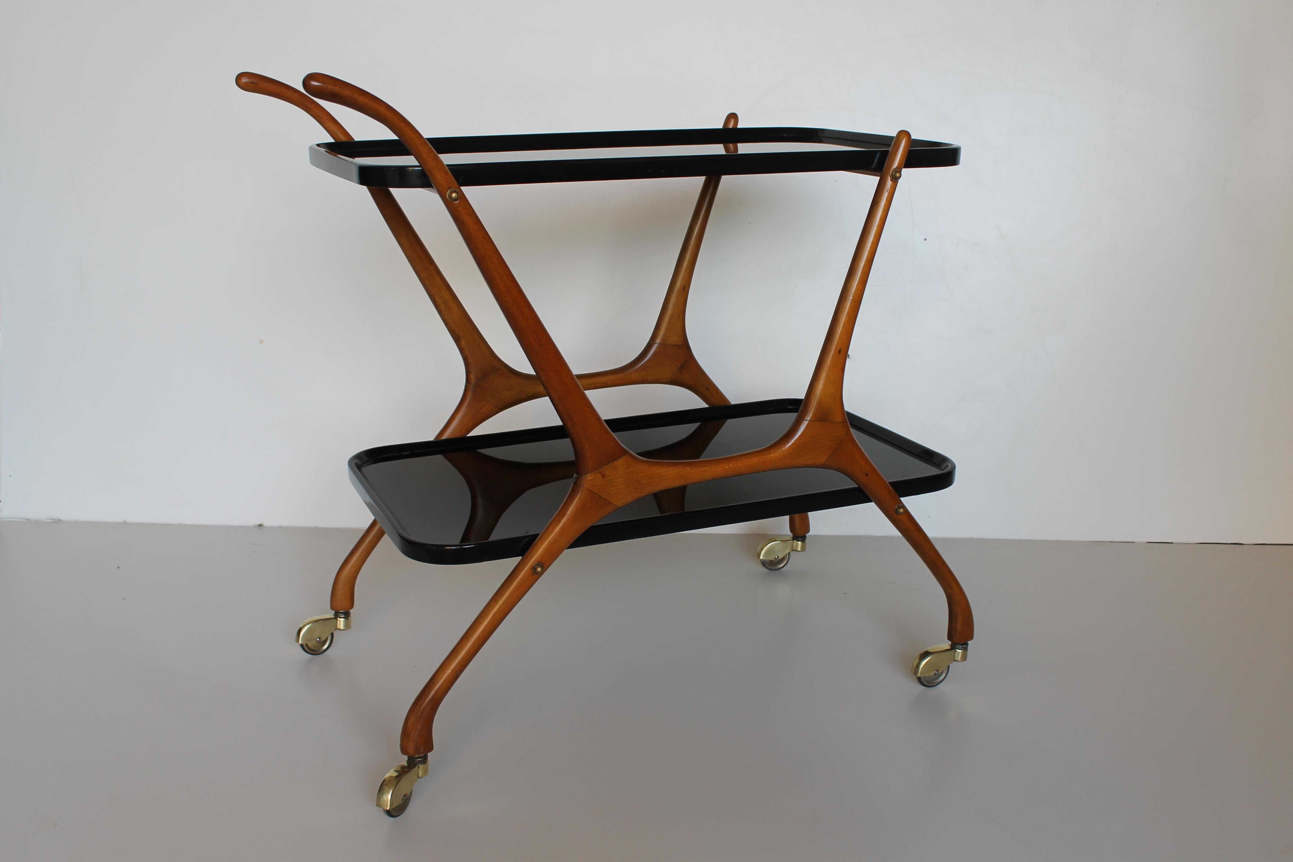 Bar cart in the style of Cesare Lacca, black opaline double shelves, beech structure and brass wheels. Dated circa 1950.
