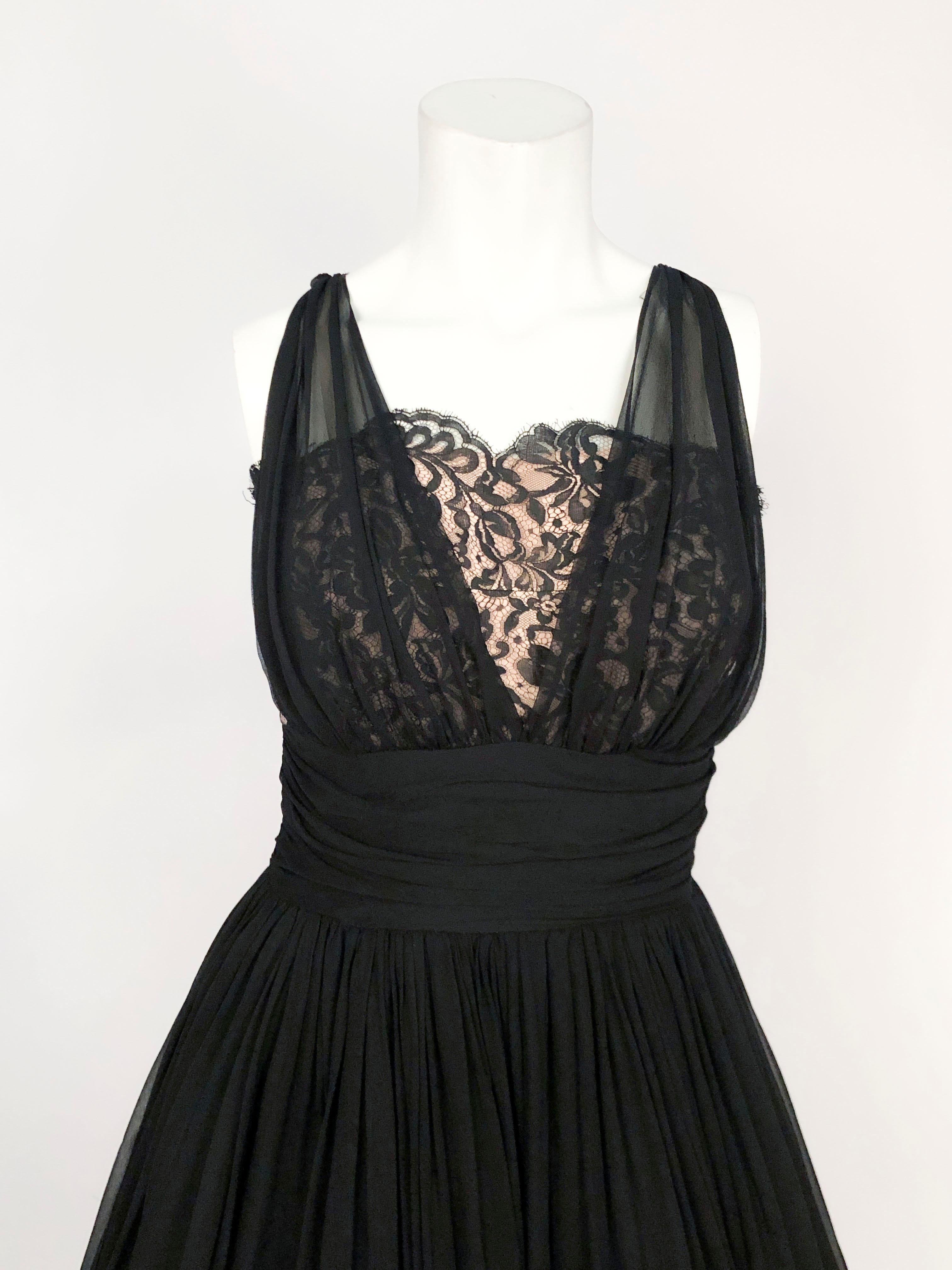 1950s Black Silk Chiffon Cocktail Dress with full skirt, draped and gathered bodice that is laid over a black lace on a blush colored silk. This piece is photographed and styled with an era appropriate petticoat that is not included with the dress.