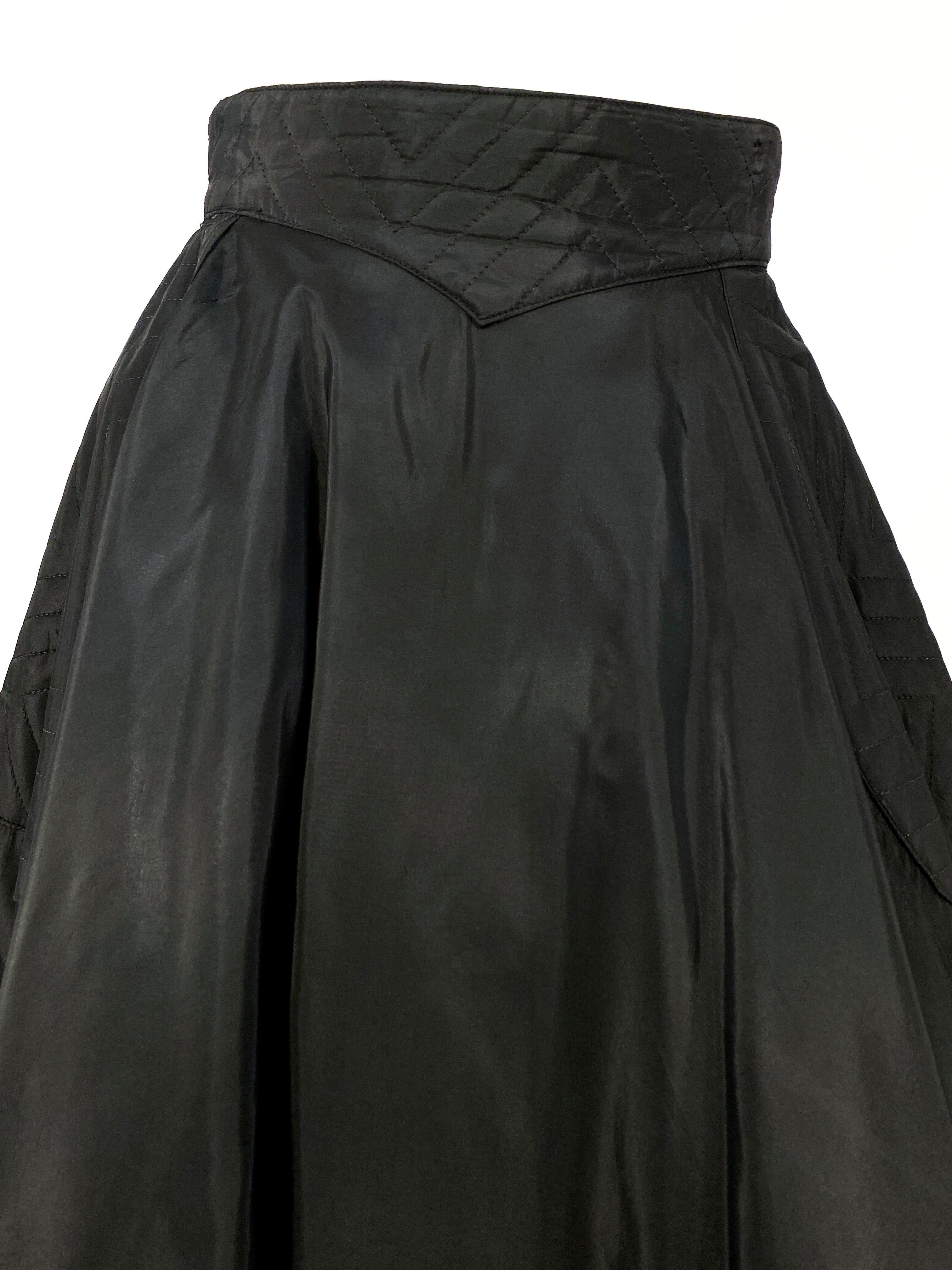 1950s black taffeta full circle skirt with quilted waist band, enlarged pockets, and wide bordered hem. This piece is meant to be worn with a full petticoat and is photographed with one that is not included in the purchase.