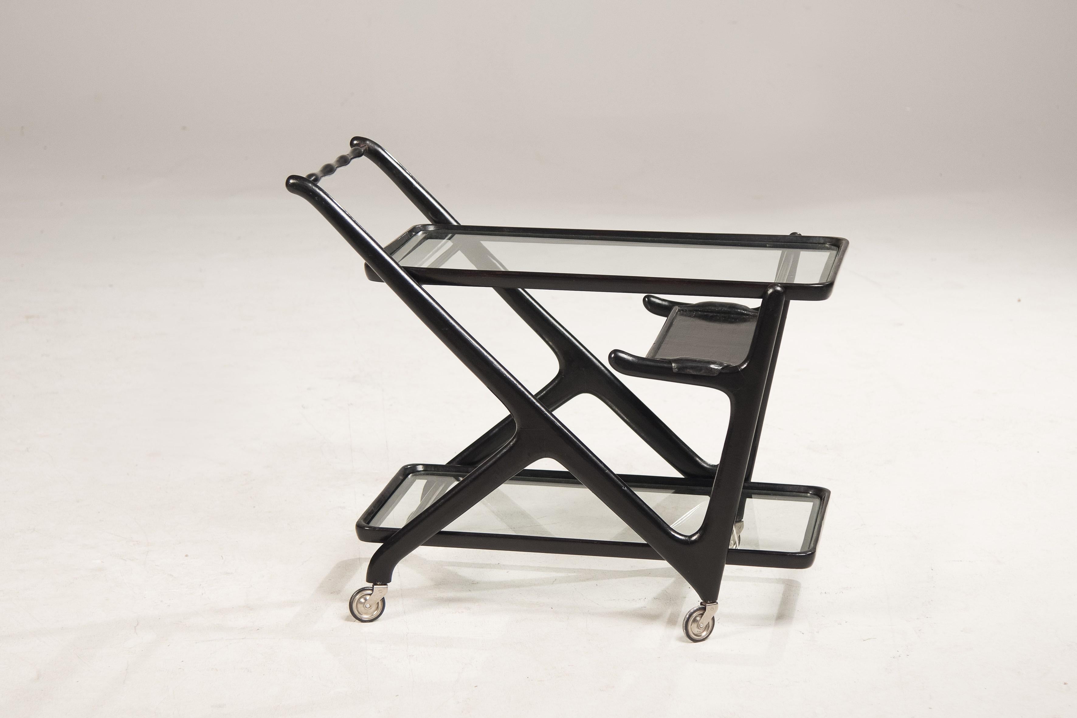1950s cart by Cesare Lacca for Cassina. Ebonized wood and original glasses, wheels and tray. Conservative restoration.