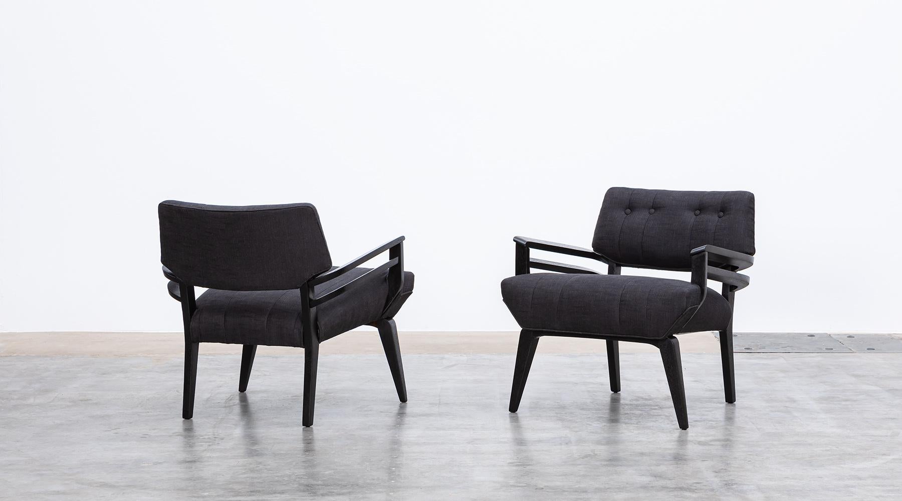 Matching lounge chairs, black lacquered wood, new upholstery, Paul Laszlo, USA, 1950.

These two pieces come in an extraordinary design by Paul Laszlo. Starting with the double armrests, the seat height and the construction of the legs.The Lounge