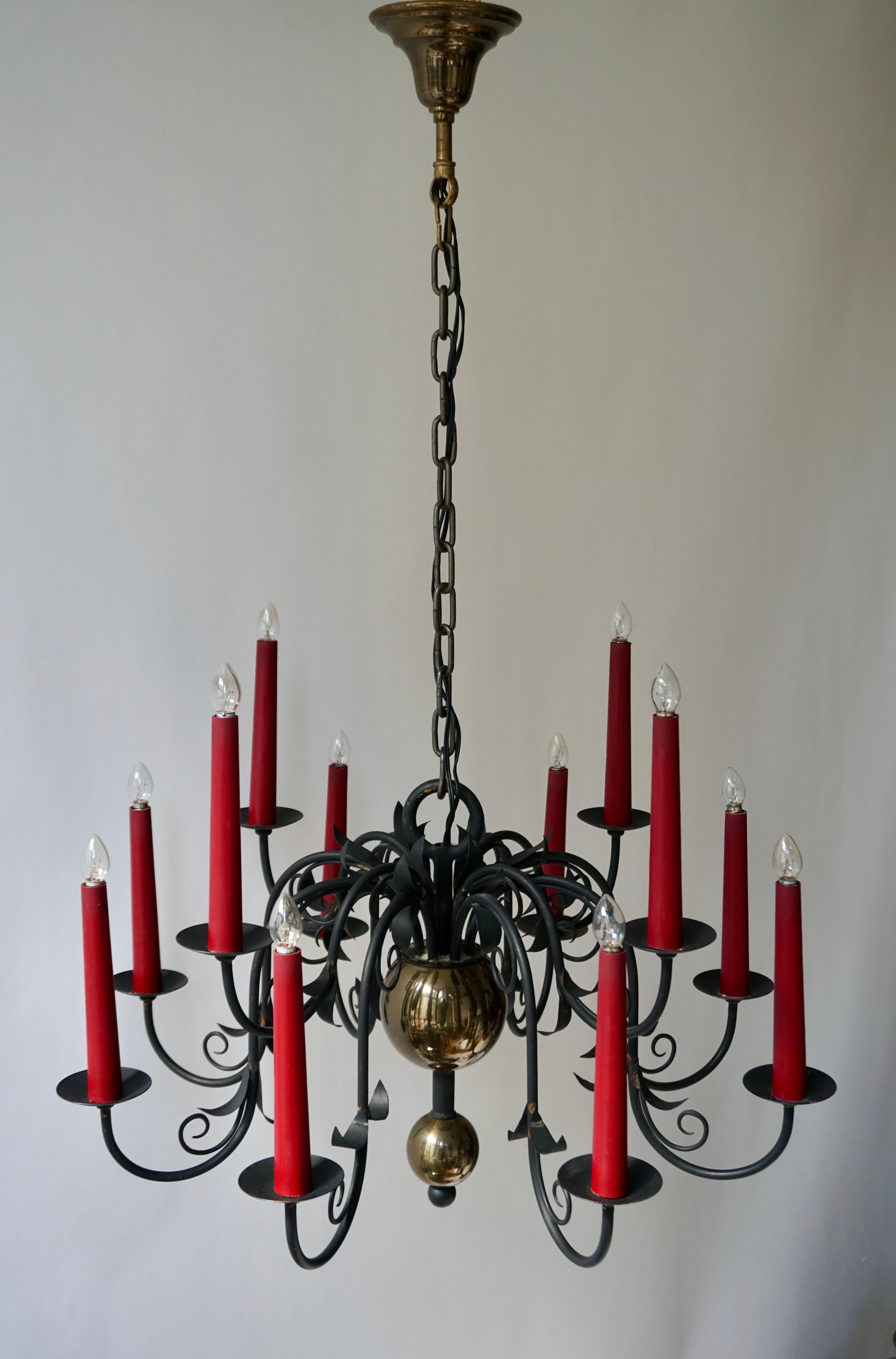 1950s wrought iron Gothic style black chandelier featuring twelve red candle sleeves.
Add the perfect amount of shine to your kitchen over the center island, living room or dining room with this elegant chandelier.

Measures: Diameter 67 cm,