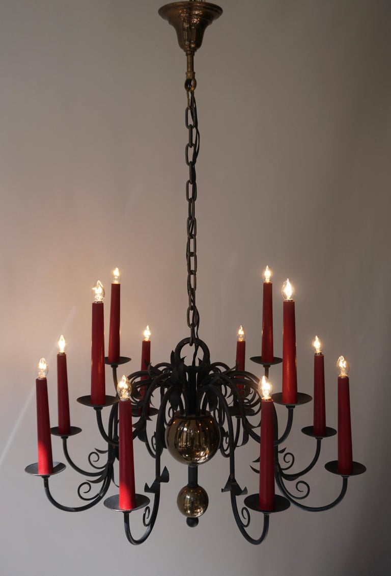 Belgian 1950s Black Wrought Iron Gothic Chandelier with 12 Red Candlesticks For Sale